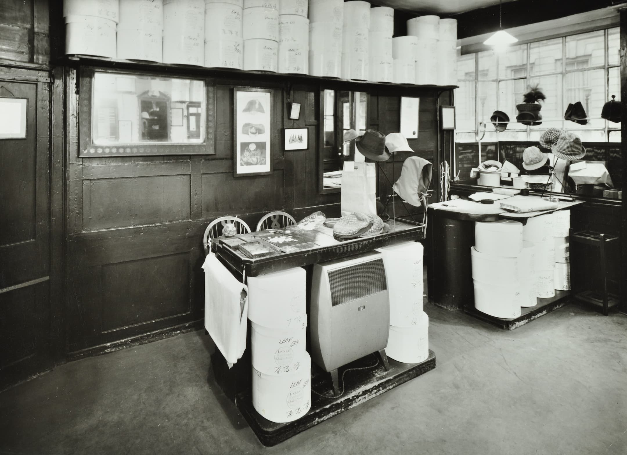 hat boxes are stacked up and hats are on display
