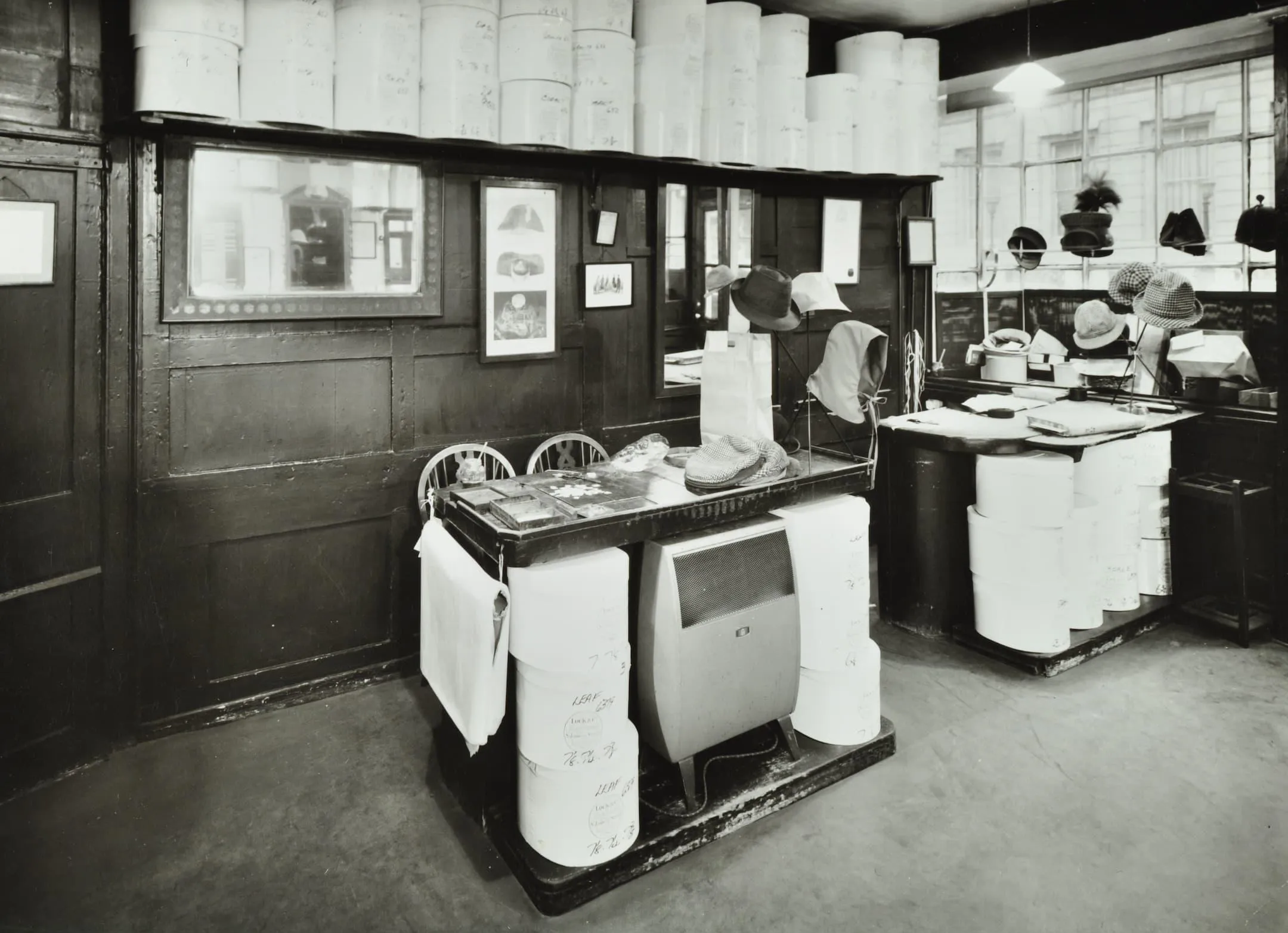 hat boxes are stacked up and hats are on display