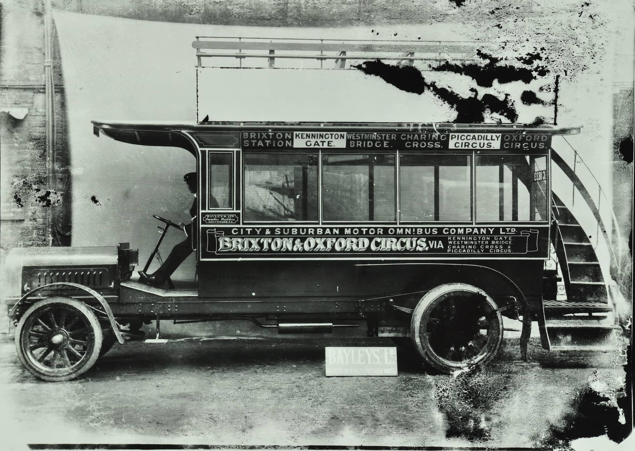 An omnibus with the words Brixton and Oxford Circus along the side.