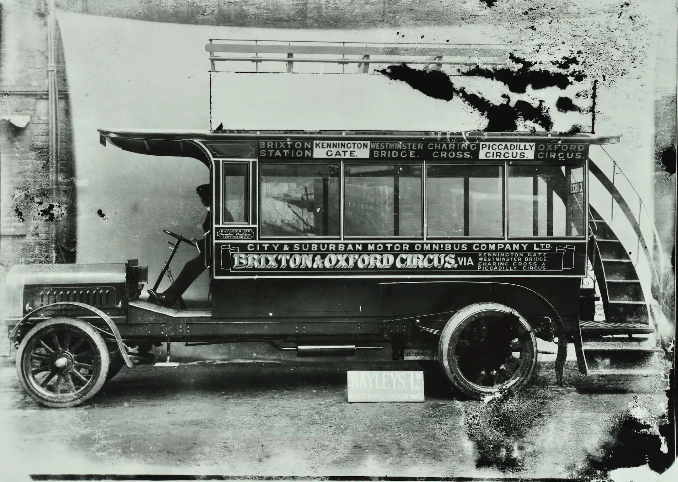 An omnibus with the words Brixton and Oxford Circus along the side.