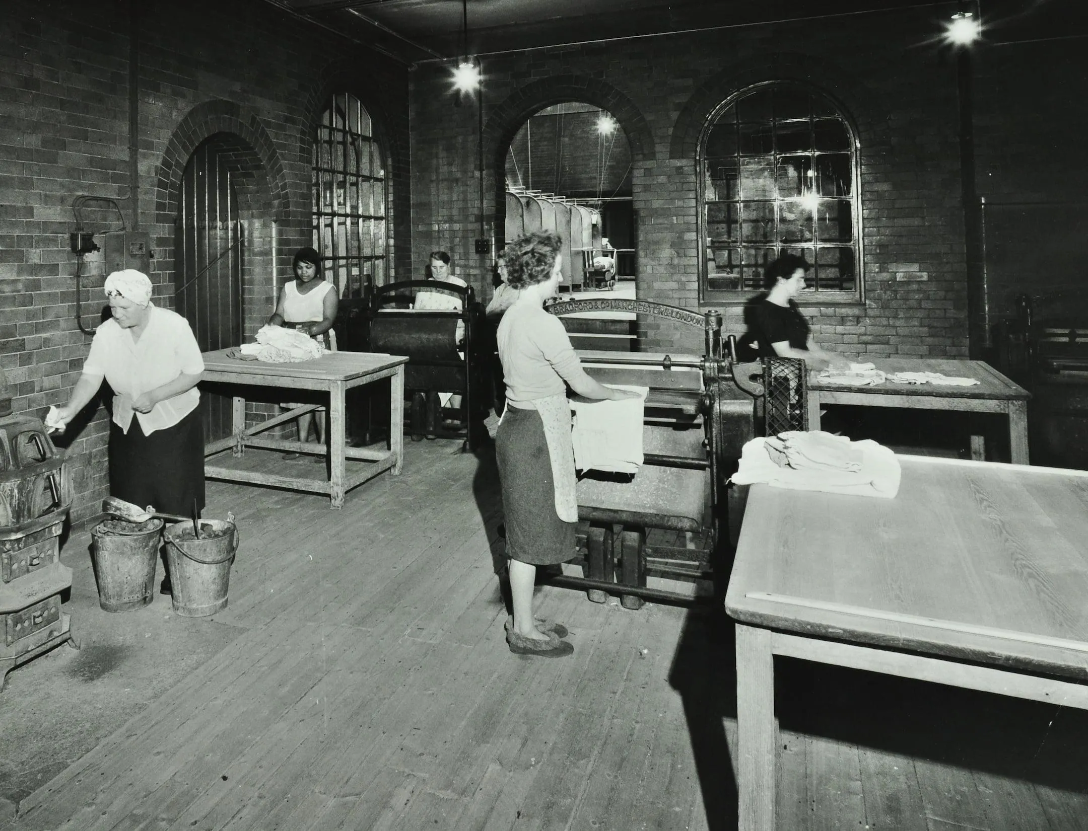 a laundry room with a mangle and buckets