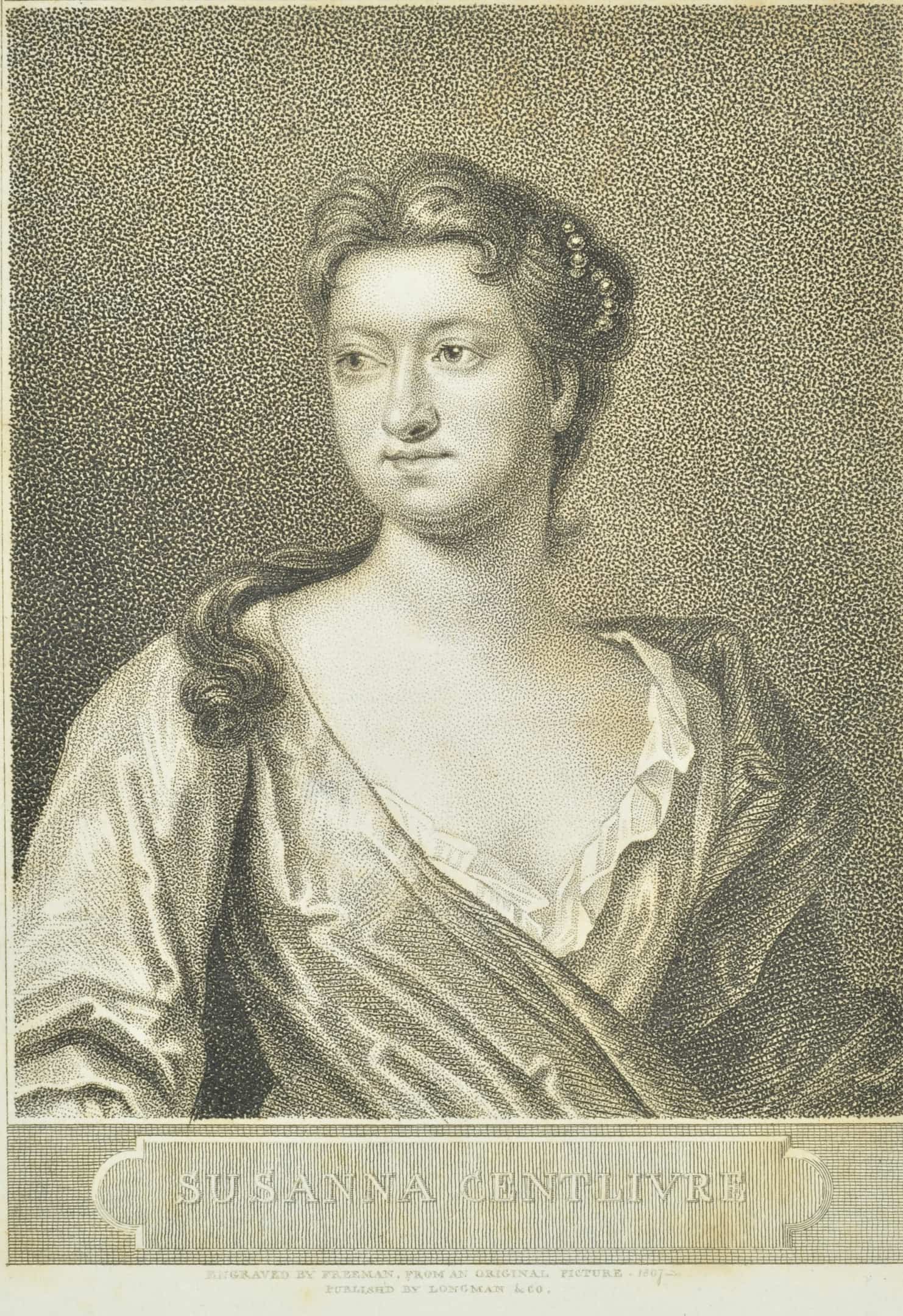 a woman with long hair pulled back and low gown