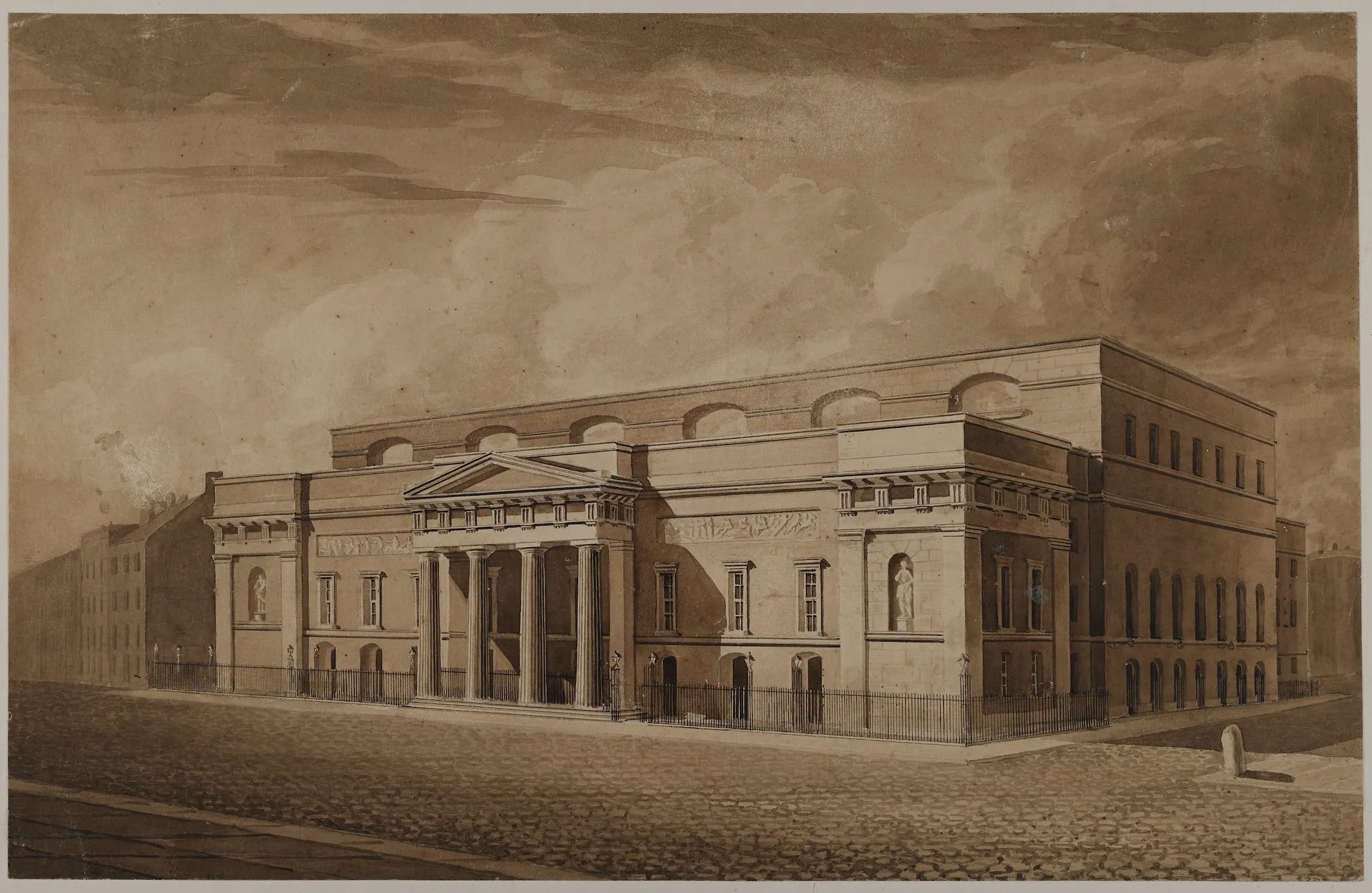 a classical fronted building stands in a cobbled street
