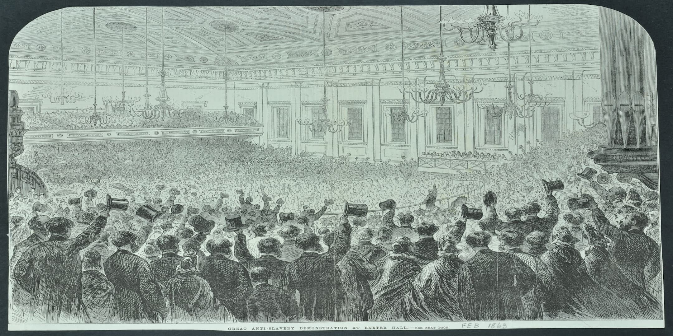 A packed hall with men waving their top hats in the air