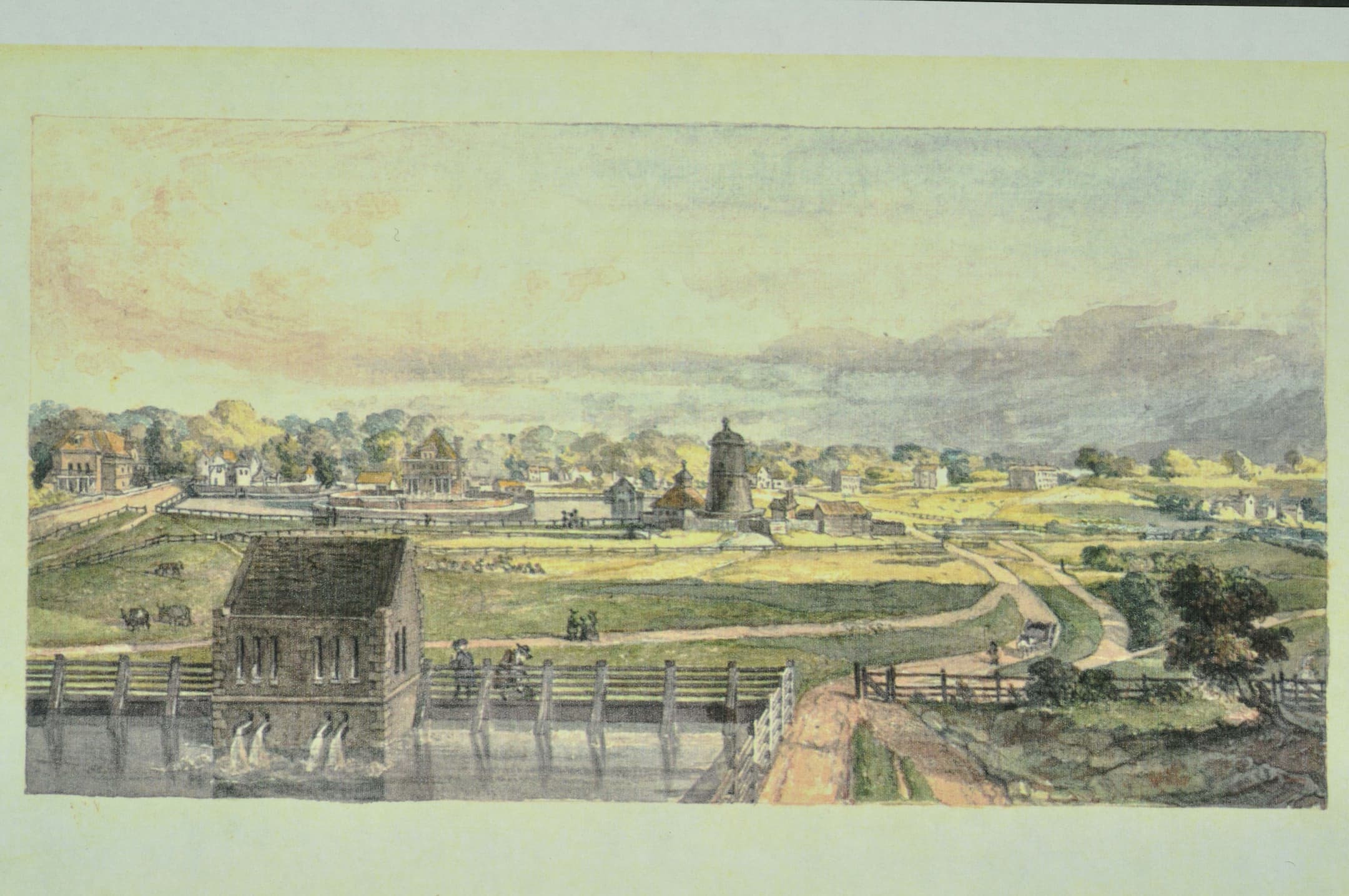 fields and a windmill base with water in the foreground
