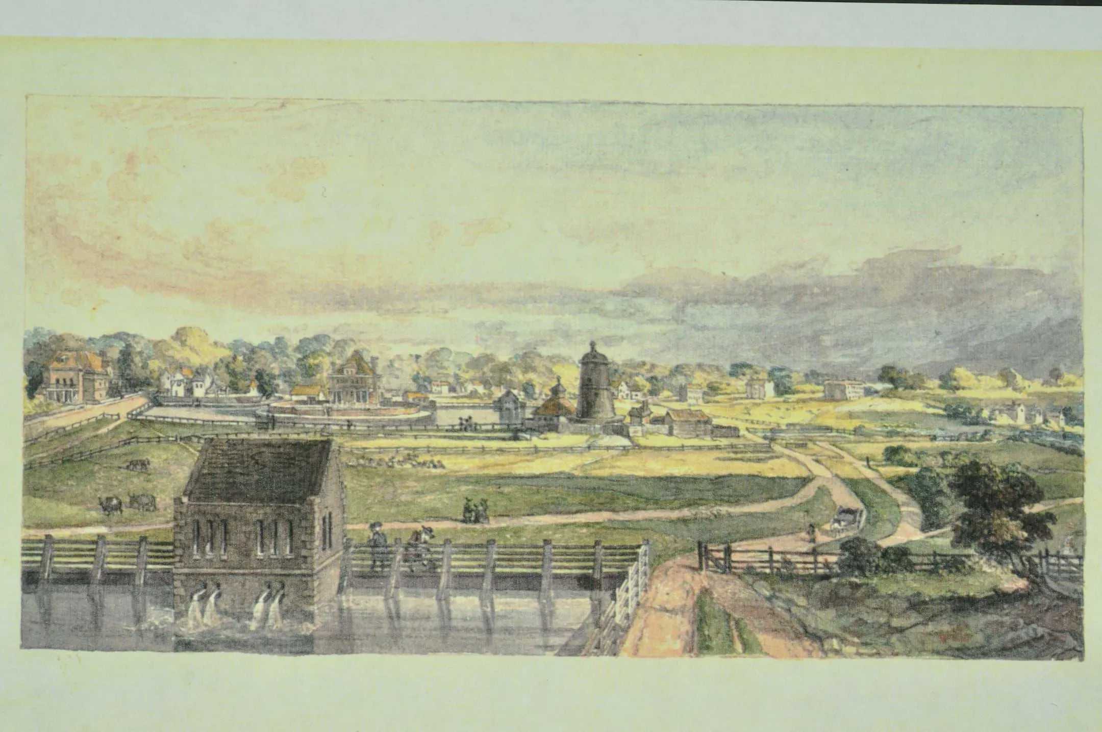 fields and a windmill base with water in the foreground