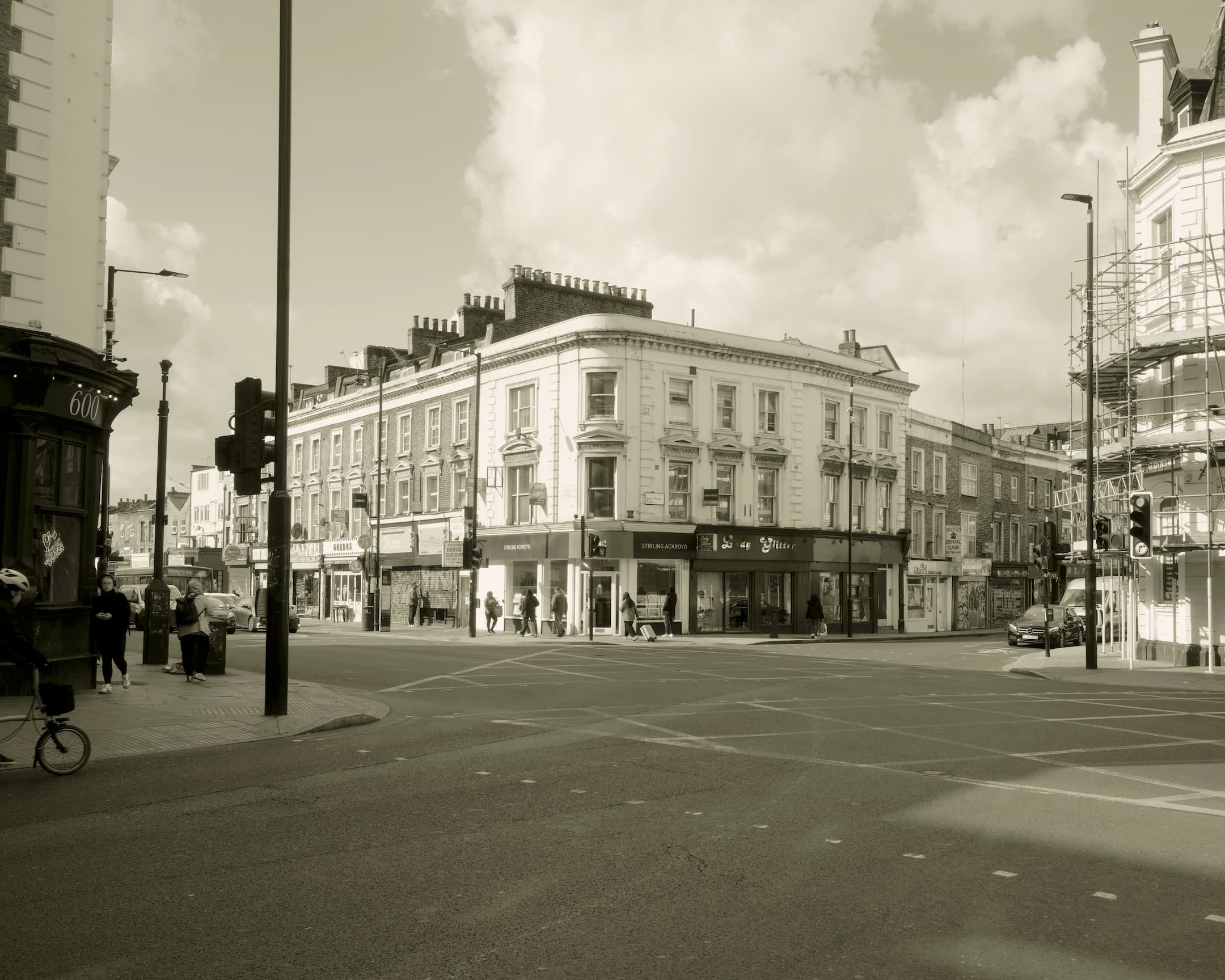 a corner building with the building opposite covered in scaffolding