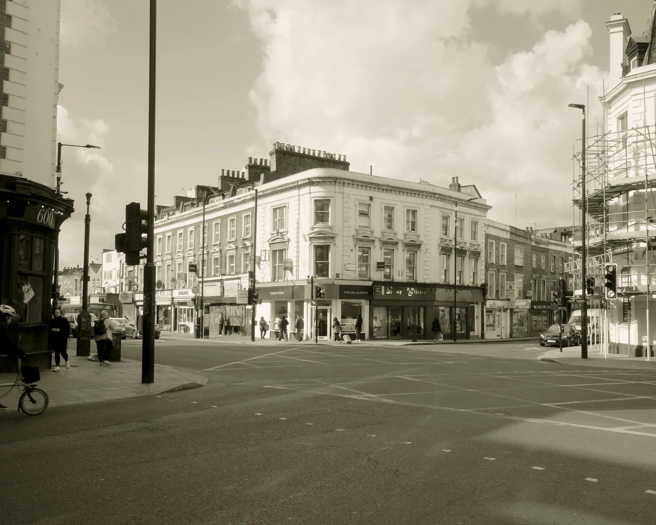 a corner building with the building opposite covered in scaffolding