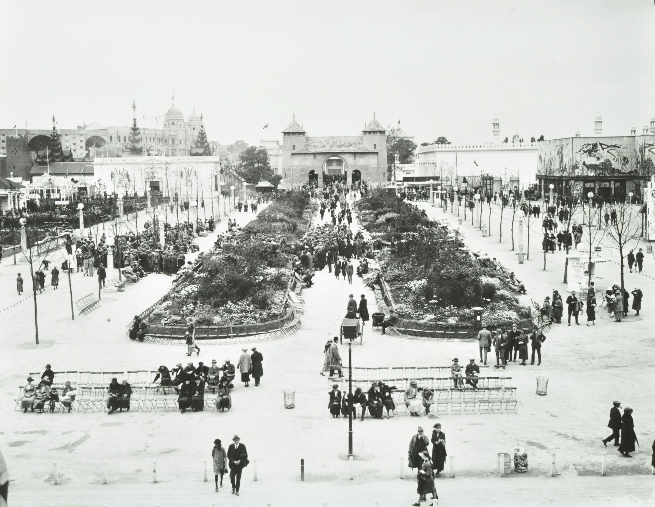 people gather in the exhibition space on the paths outside