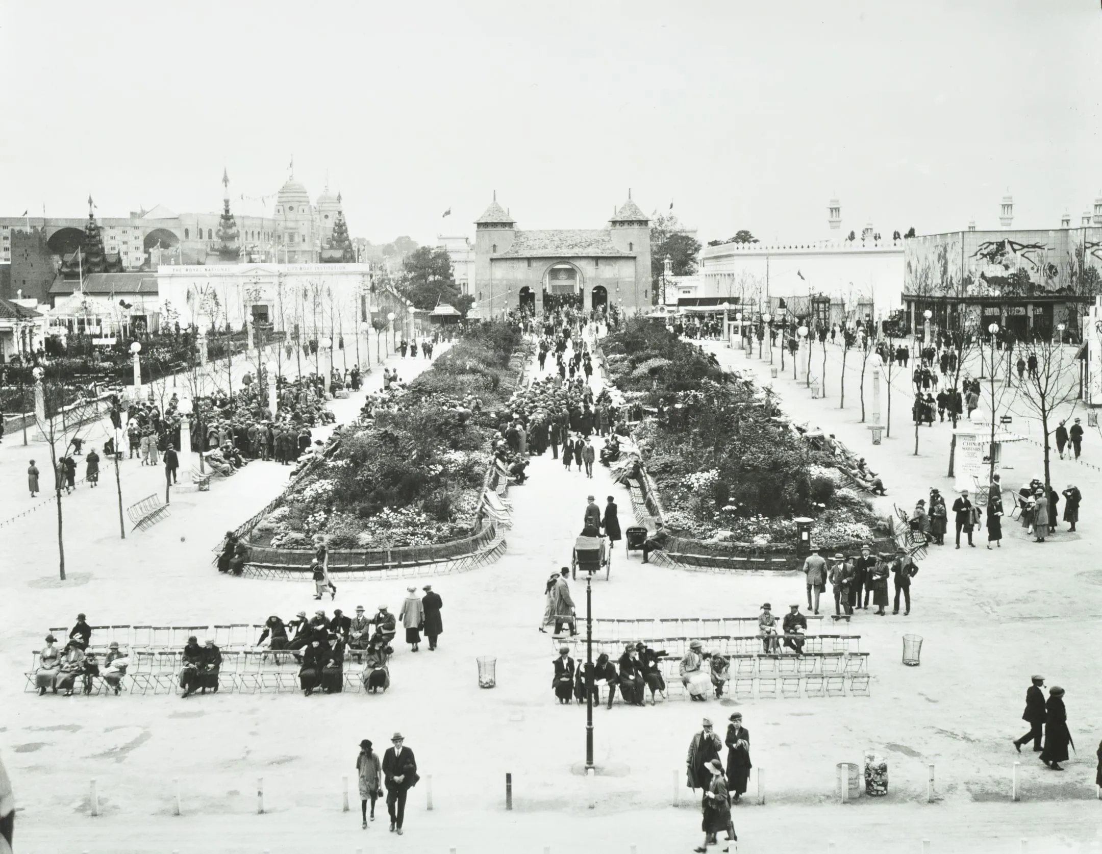 people gather in the exhibition space on the paths outside