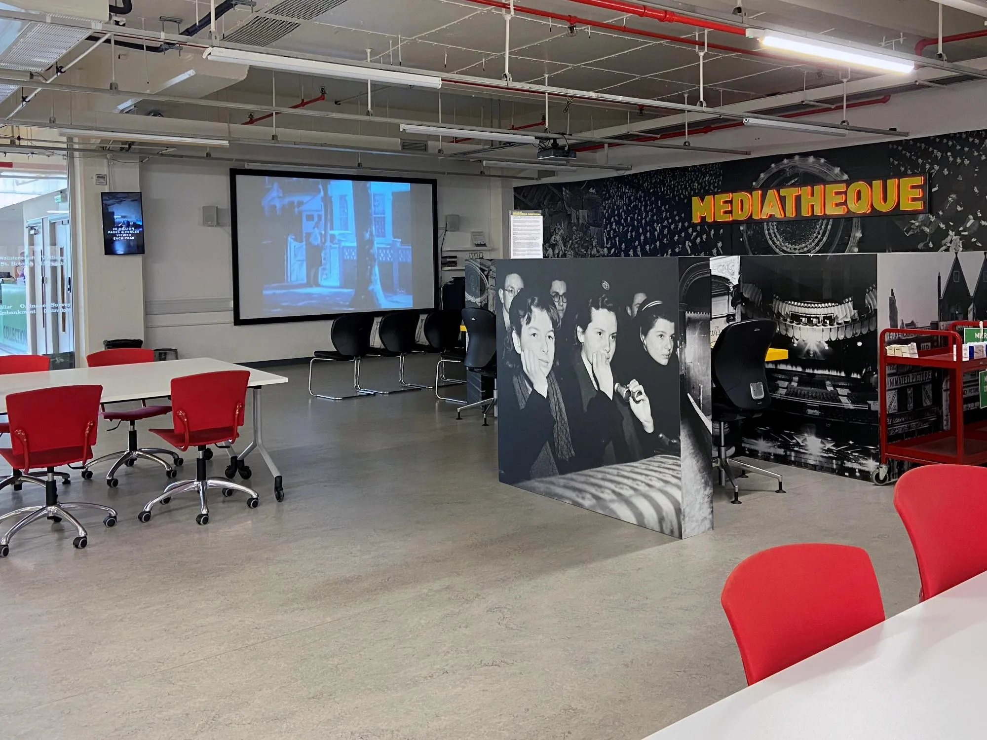 Seating and a projector screen in the Mediatheque at The London Archives