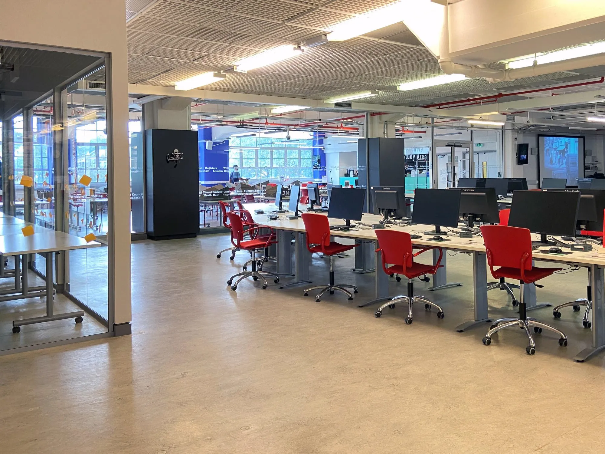 Chairs, tables and computers in the Information Area at The London Archives