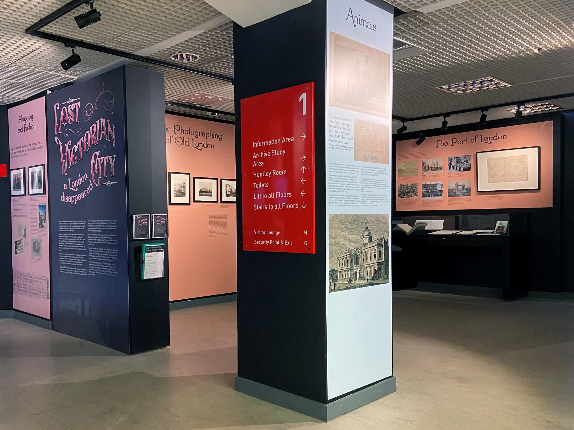 Framed pictures and printed graphics on walls in the Exhibition Space at The London Archives.