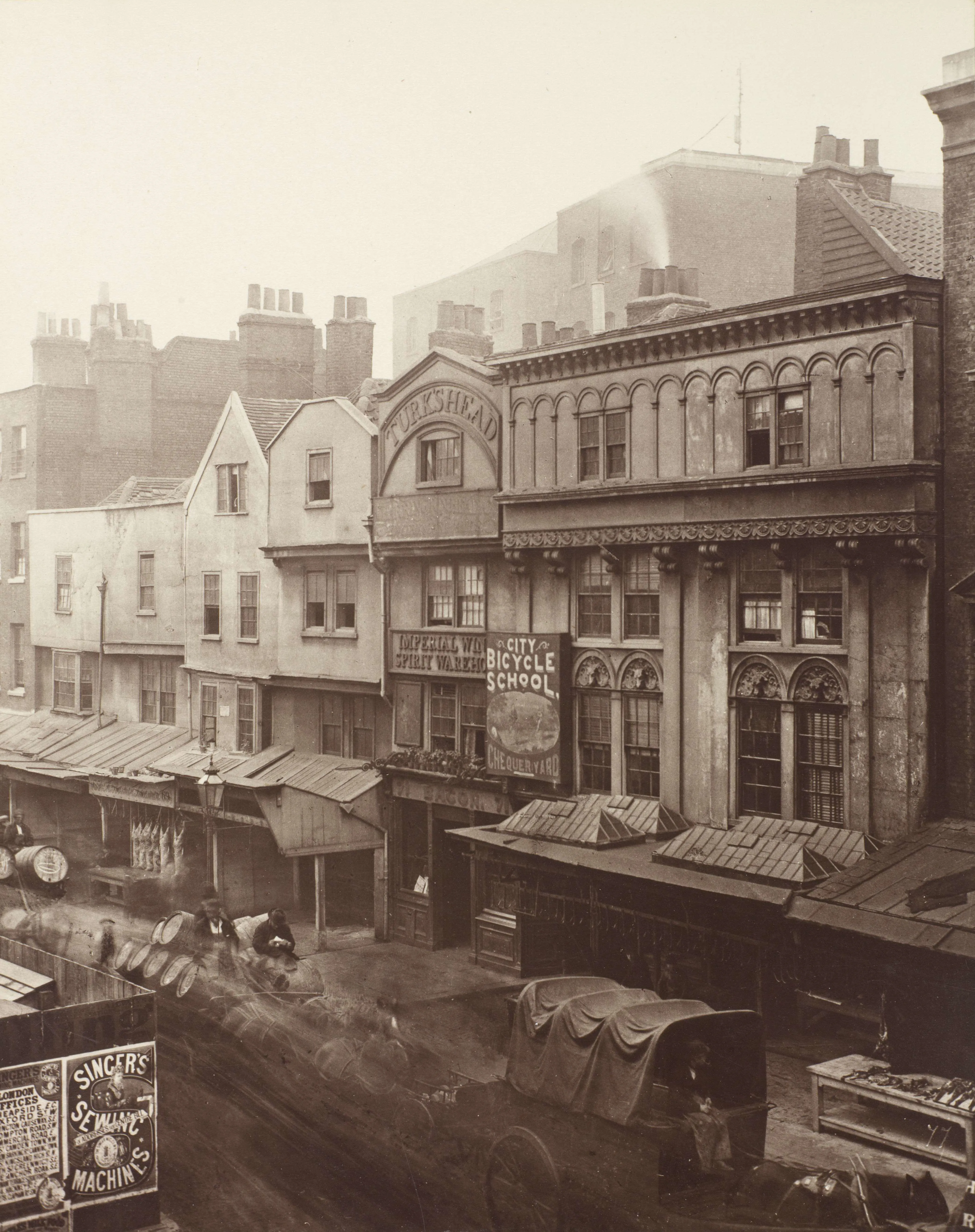shops along Aldgate High Street and the Turk's Head with a cart in the foreground