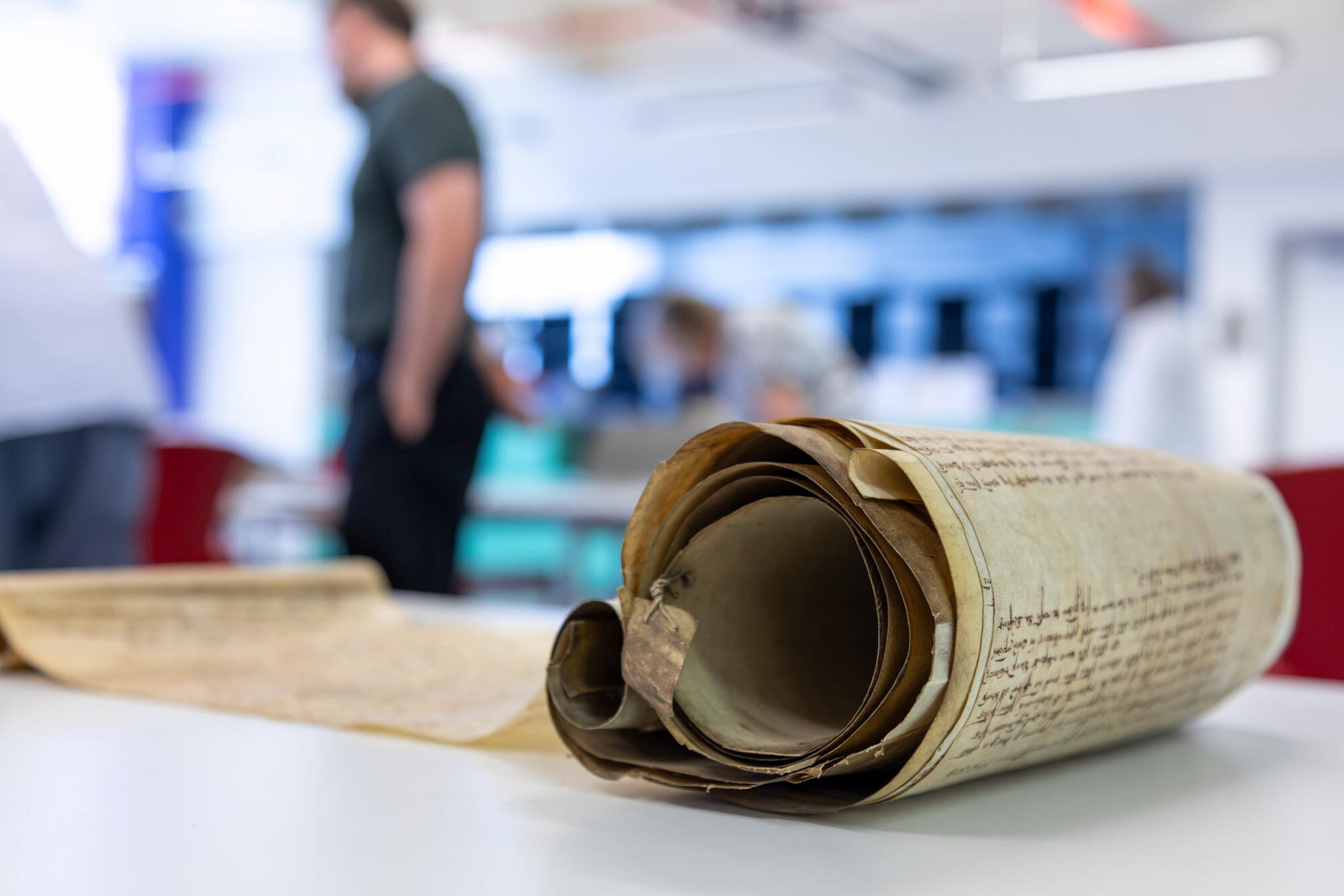 a roll on a table with a person in the background