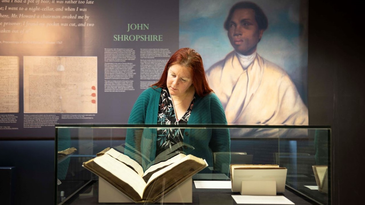 woman-viewing-unforgotten-lives-exhibition-1280