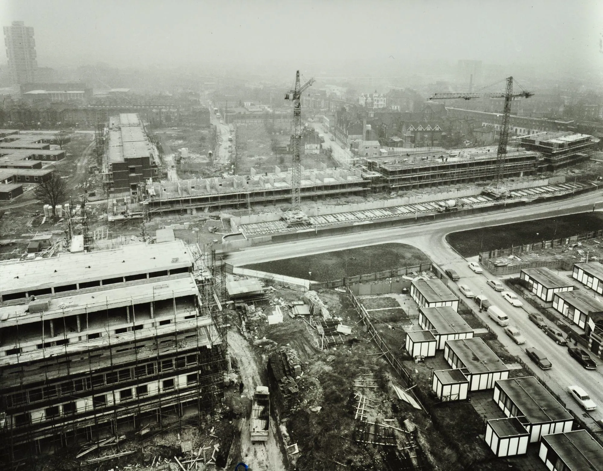 an aerial view of an estate being built with some low-rise prefabricated units in the foreground