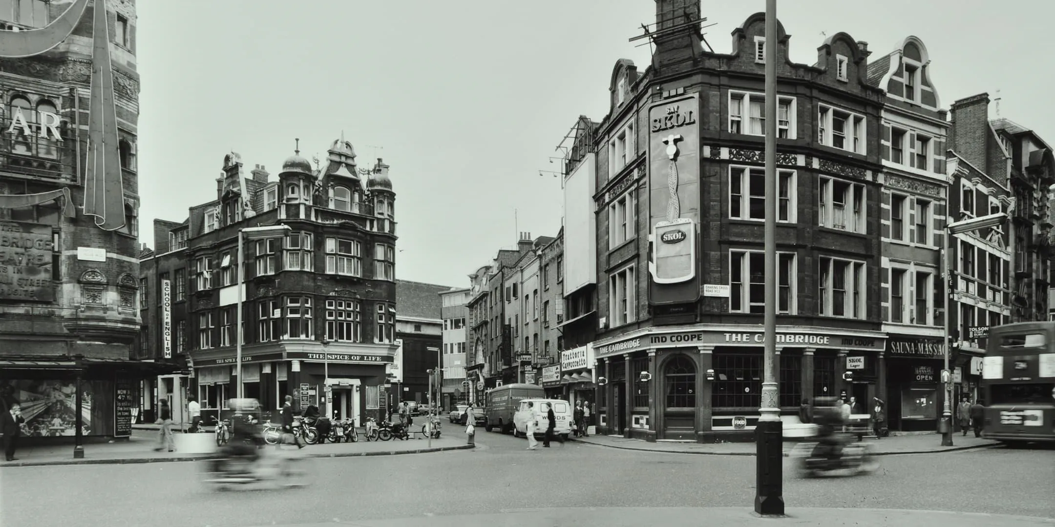 Pub and restaurant with people and traffic passing