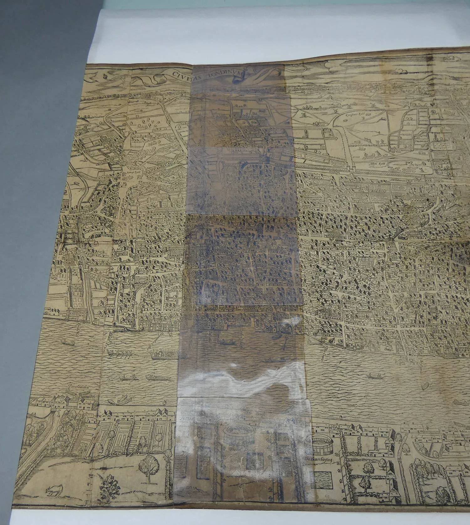 Civitas Londinum map laid on table during conservation work with a strip of gel on top
