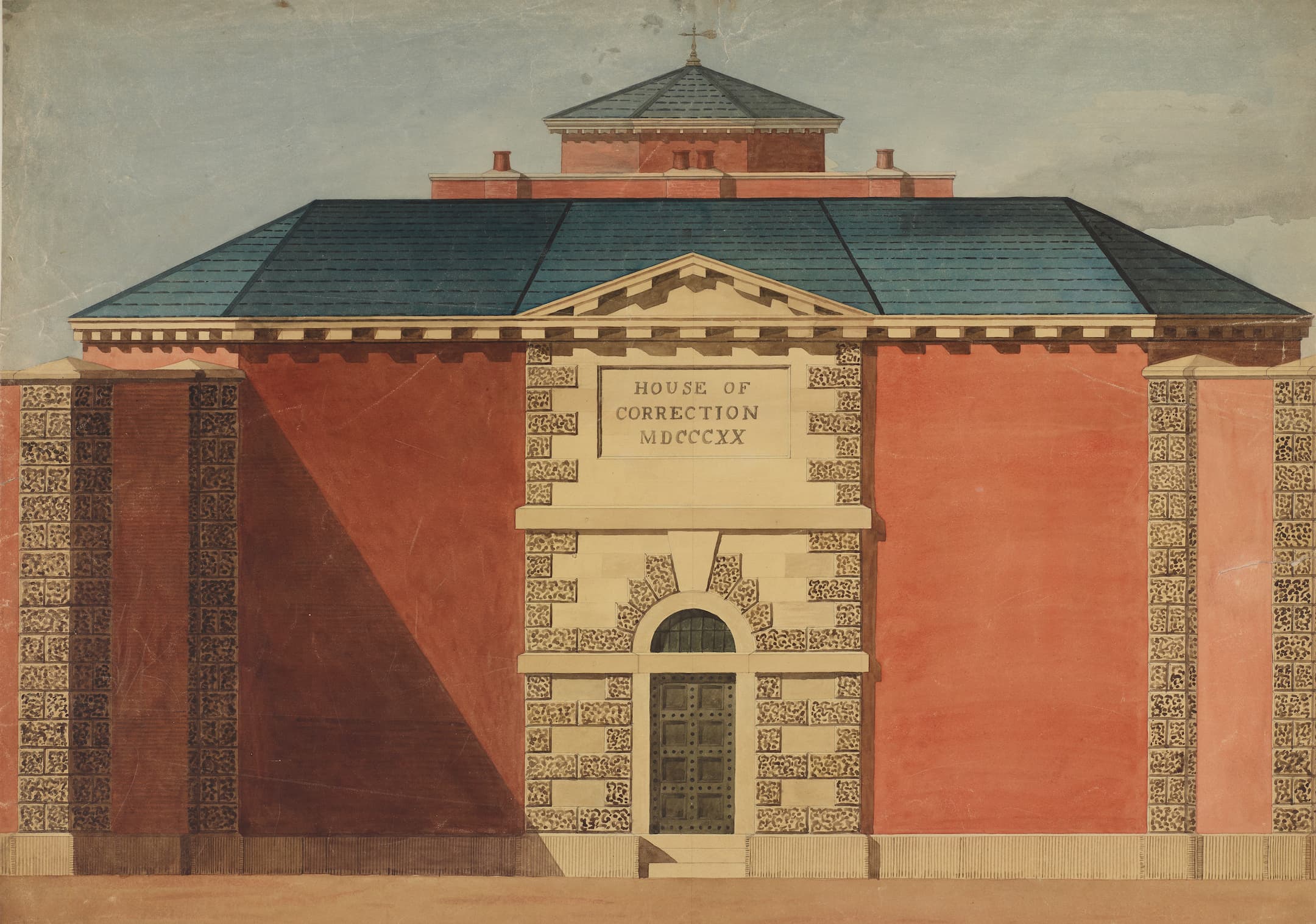 House of Correction is written on the front of this building with a strong prison door at the entrance