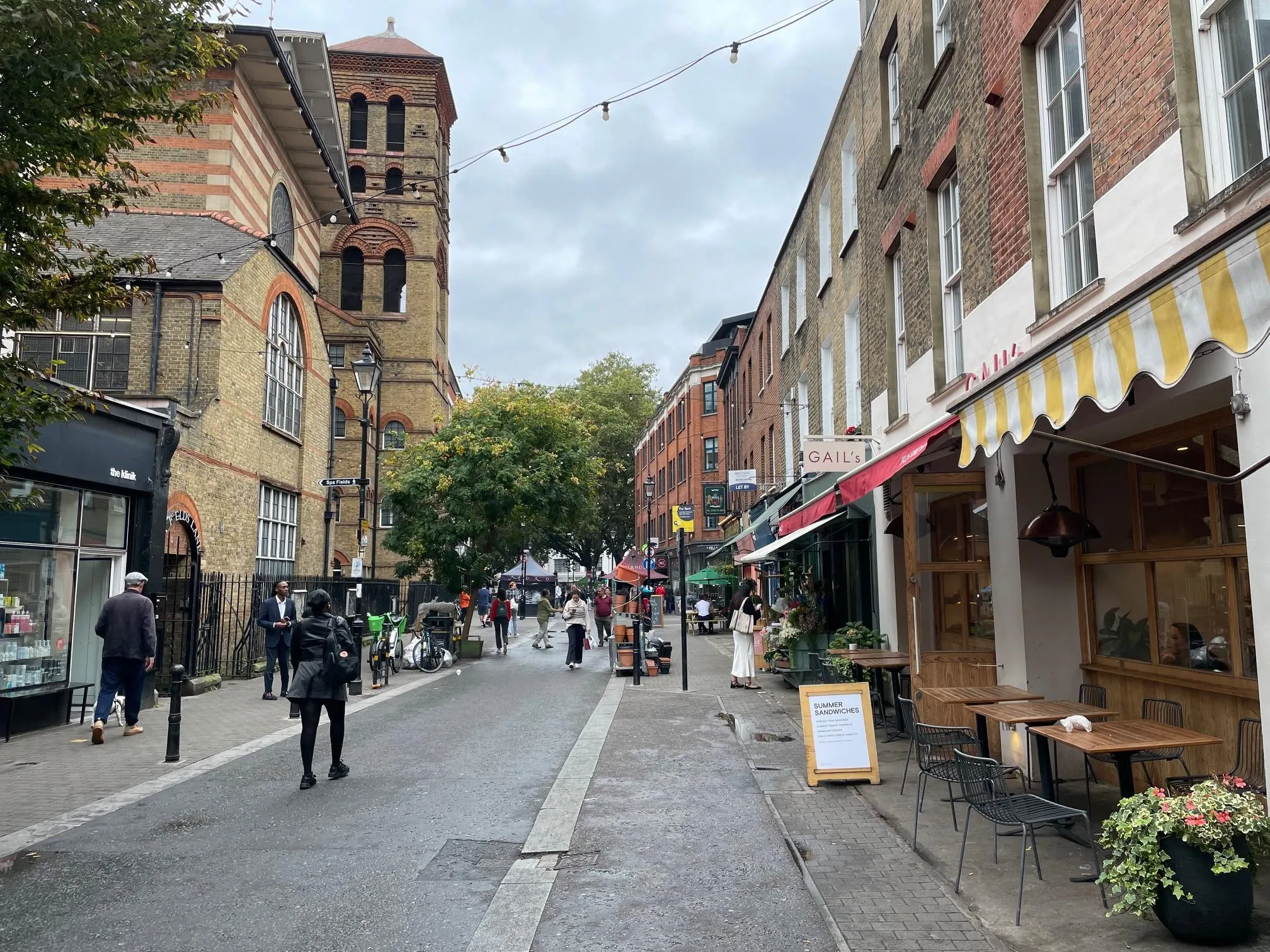 a street with cafes and a church