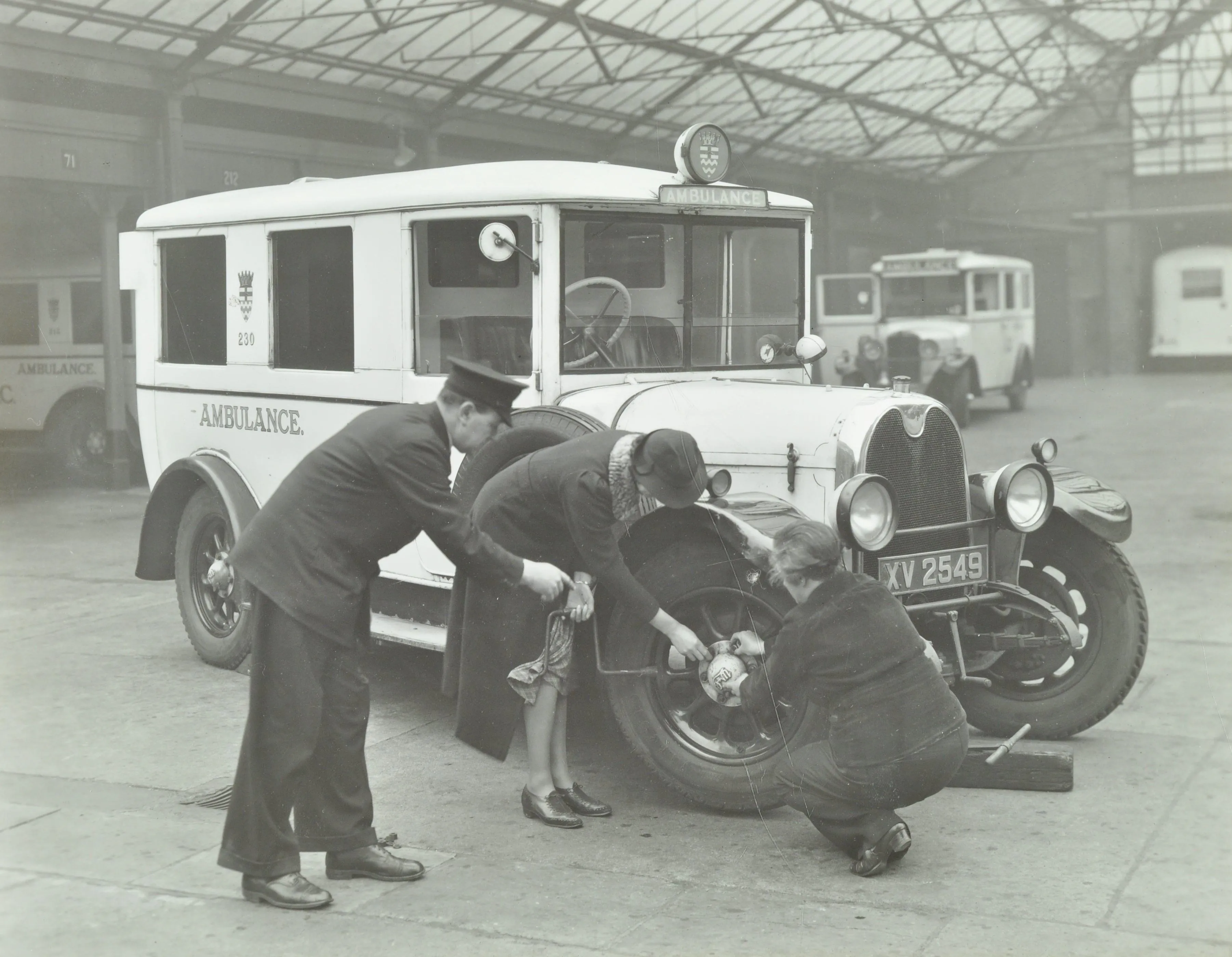 two women tend to an ambulance tire