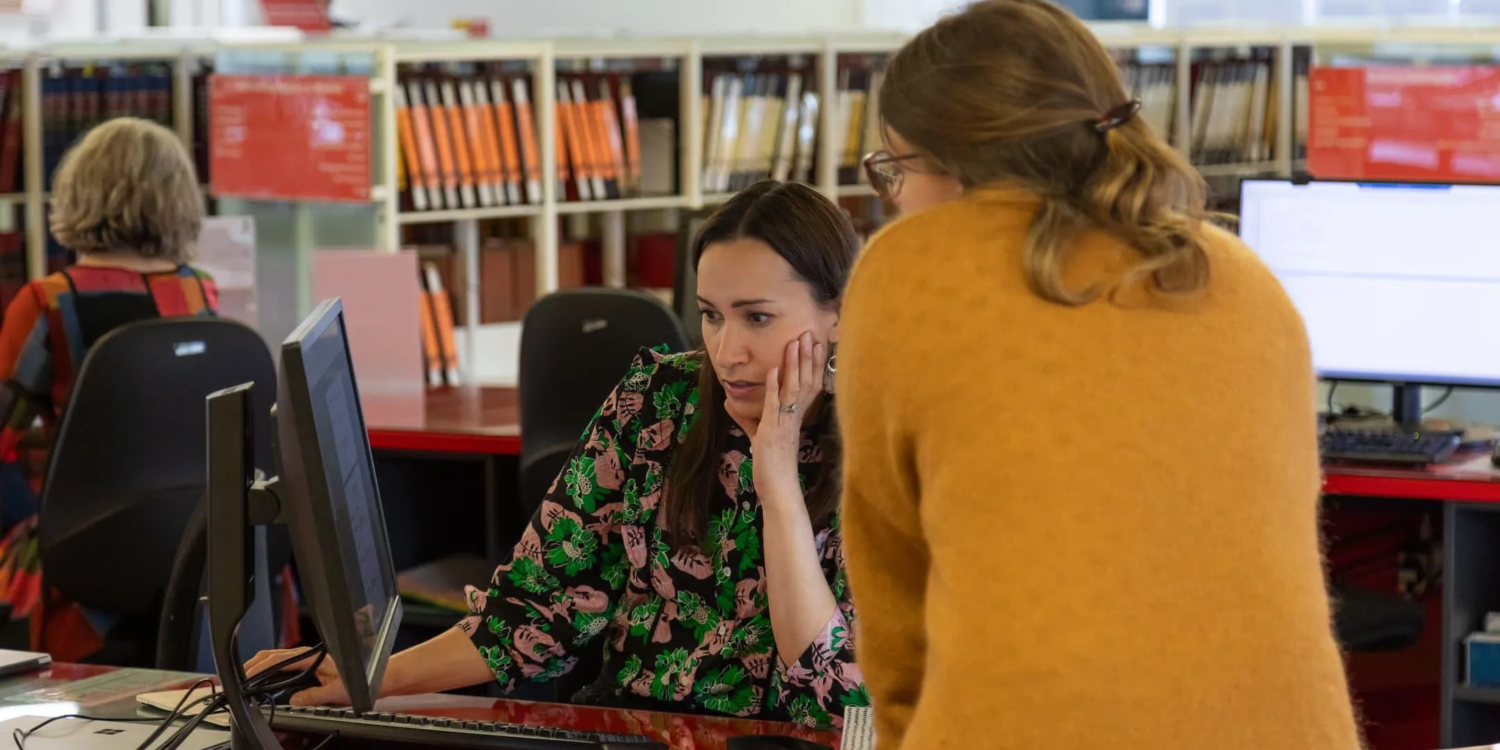 Public team helping a visitor with a family history question