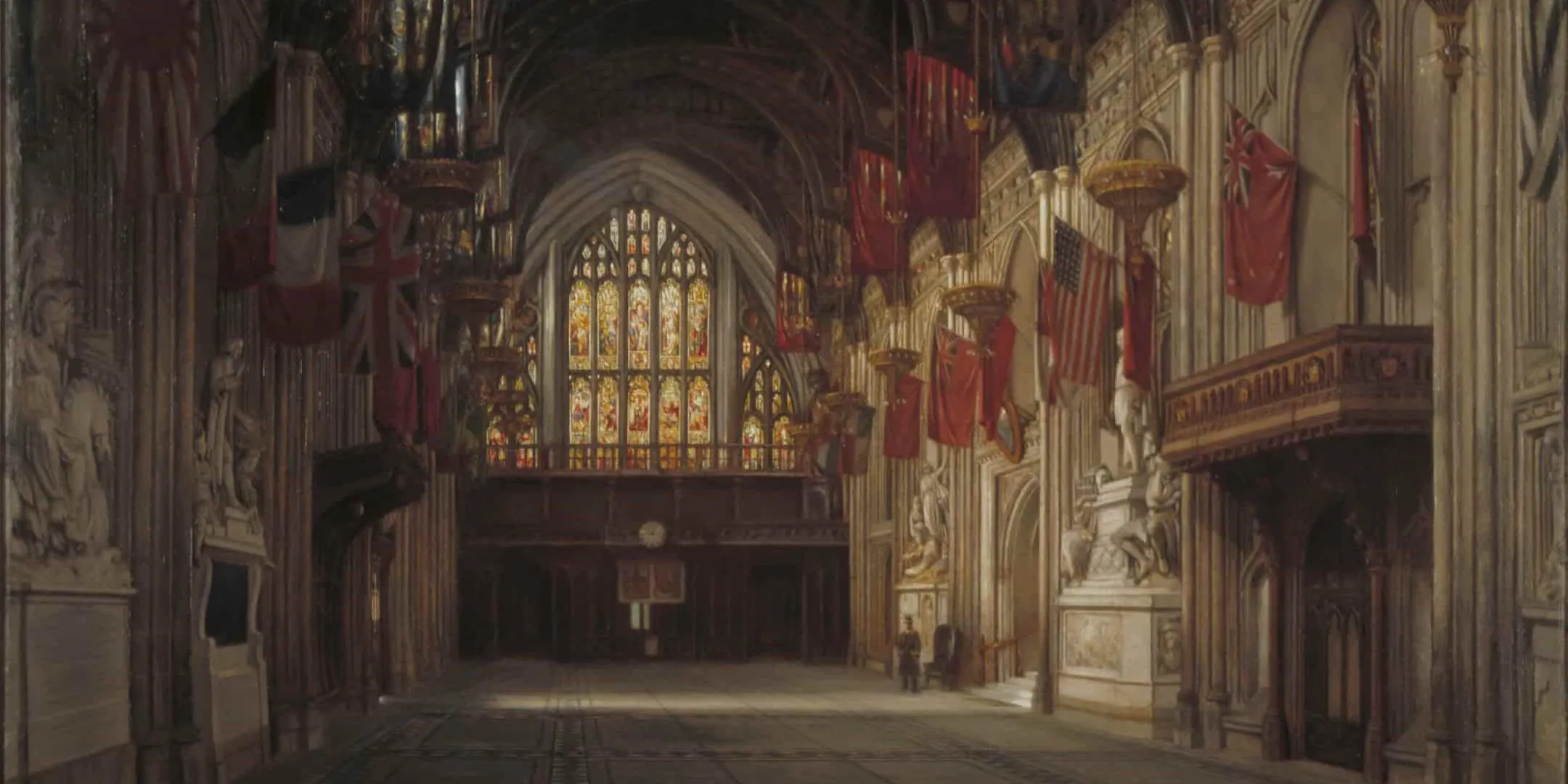 Large stained glass window display, arches form the ceiling, flags of countries hang from sides of the hall walls