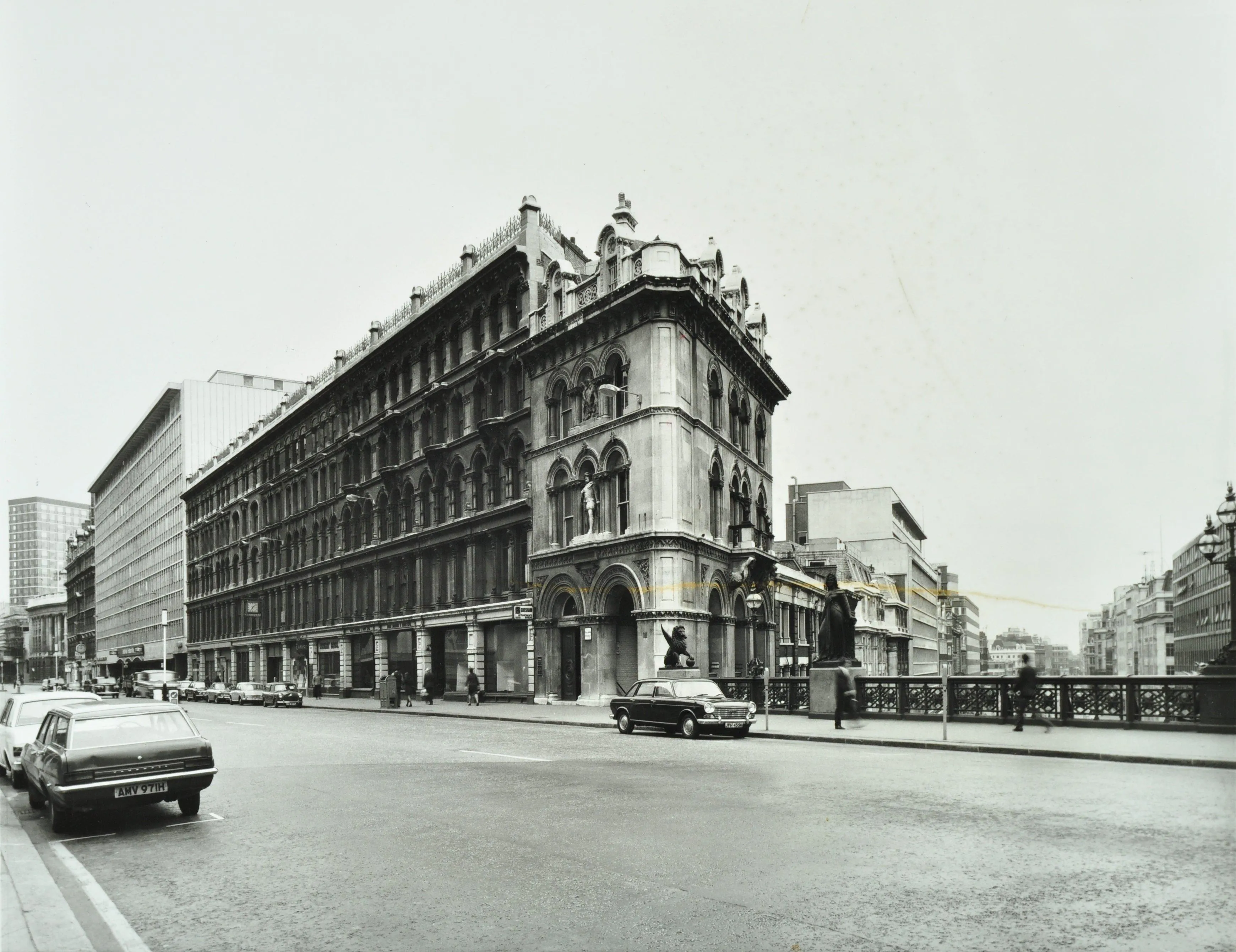 buildings over bridge at Holborn Viaduct and cars in the foreground.