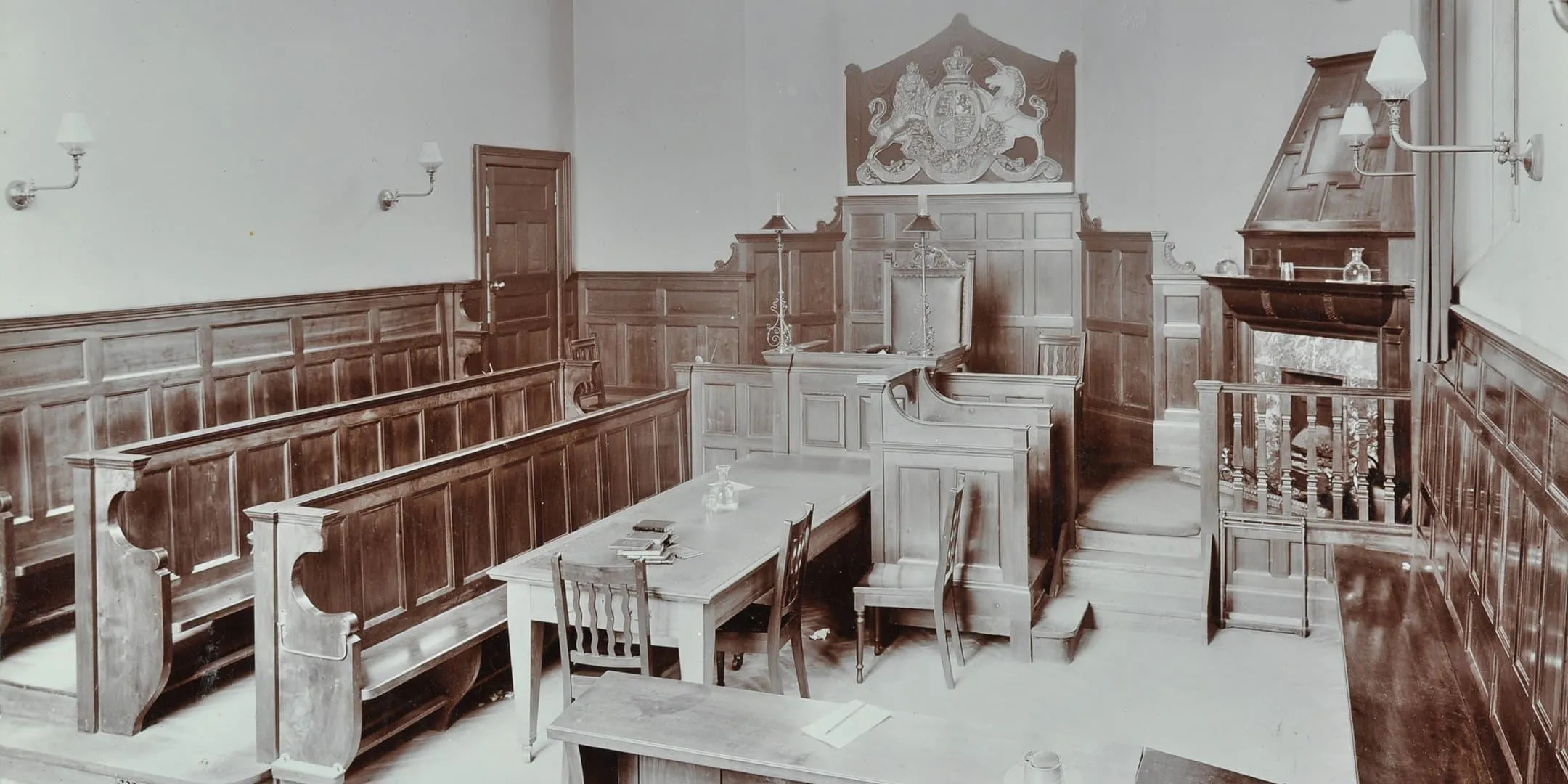 Inside of court room, with benches, chairs and tables