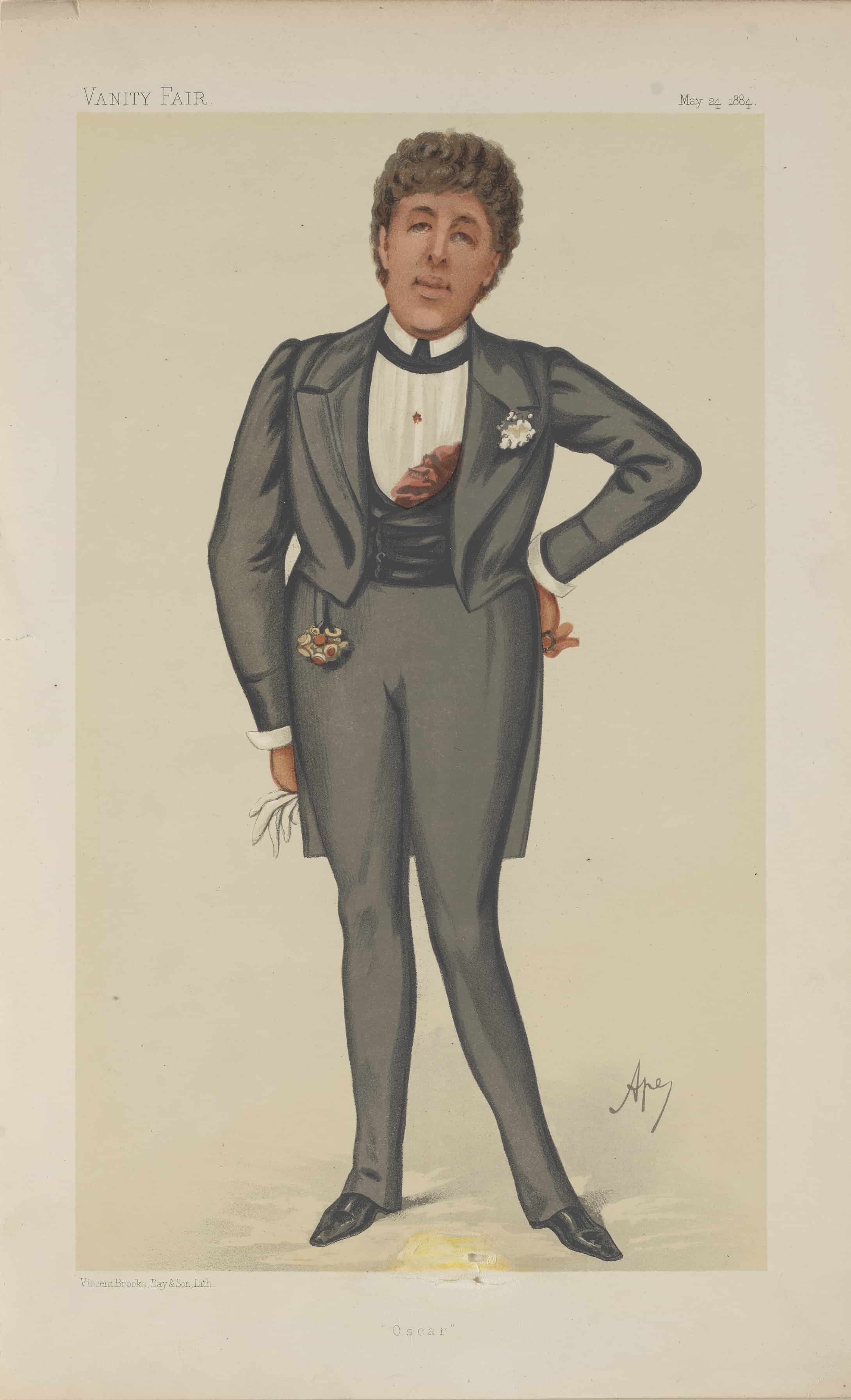 Man wearing a grey suit, flower brooch on left side of his chest. 