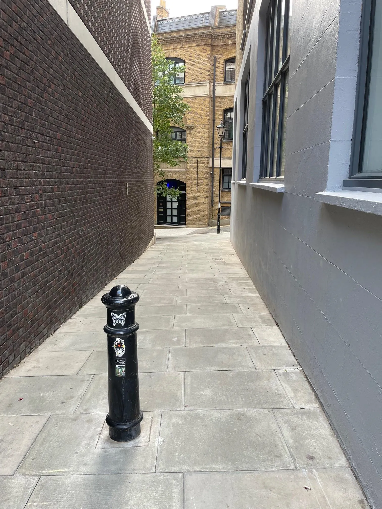 passage way with street lamp and a bollard in the foreground