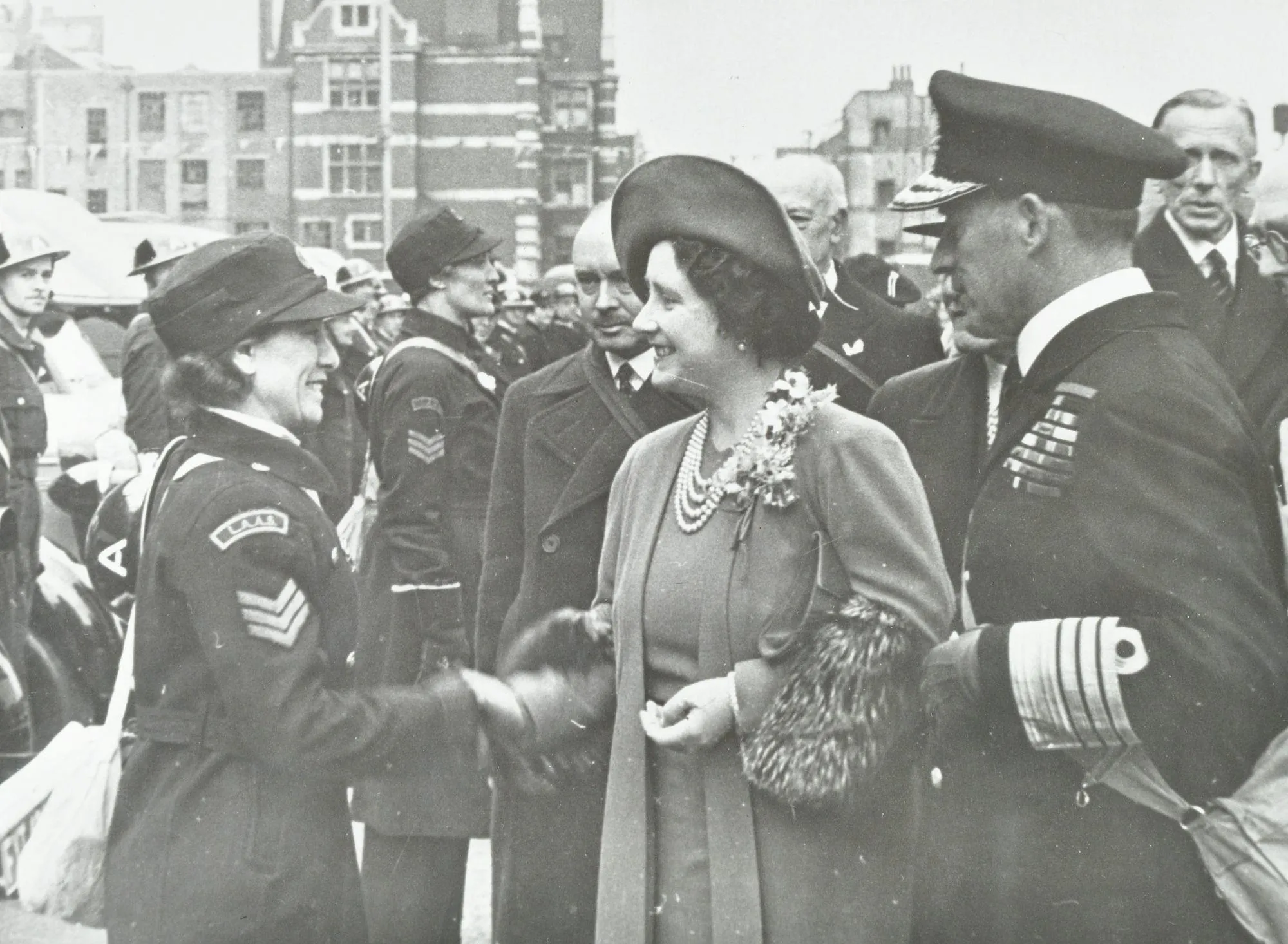 an older woman shakes the hands of a female ambulance driver