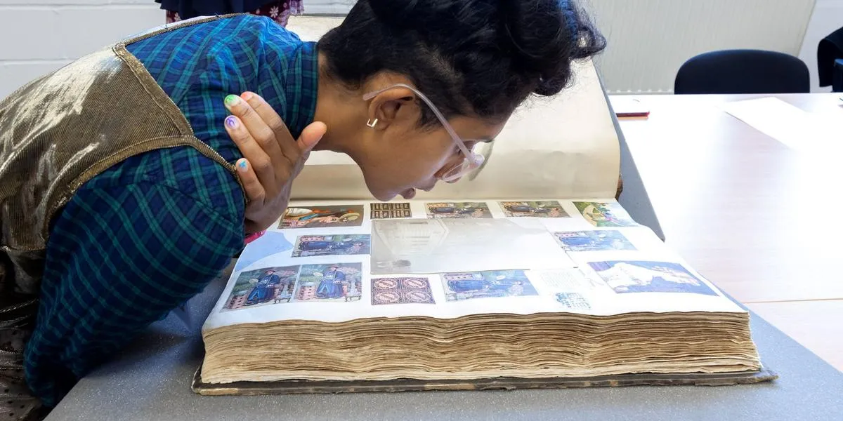 researcher-viewing-photos-from-the-archive