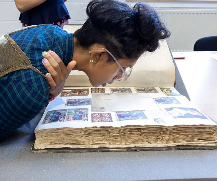 researcher-viewing-photos-from-the-archive