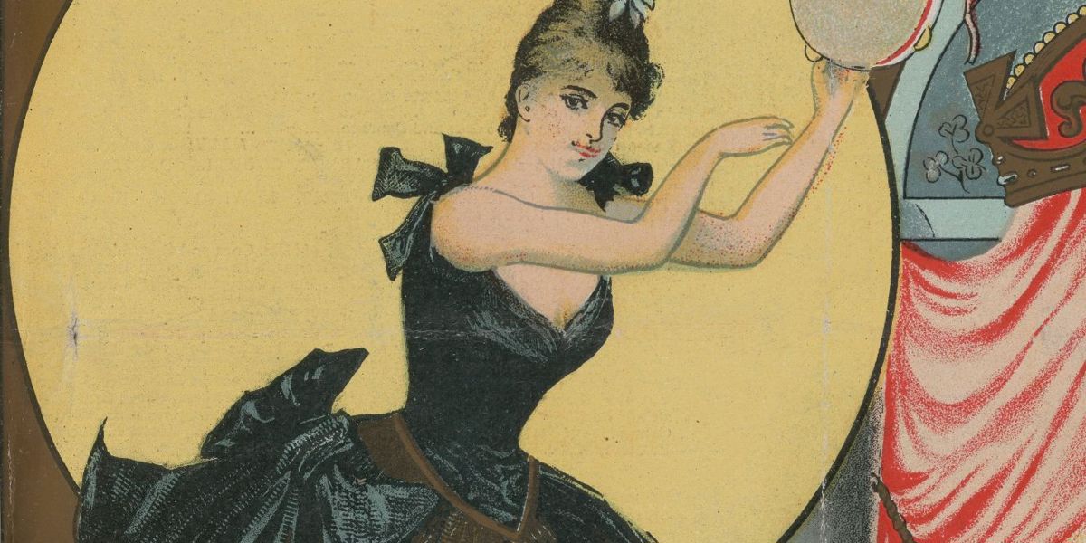 A woman in a tutu holding a tambourine on a theatre stage