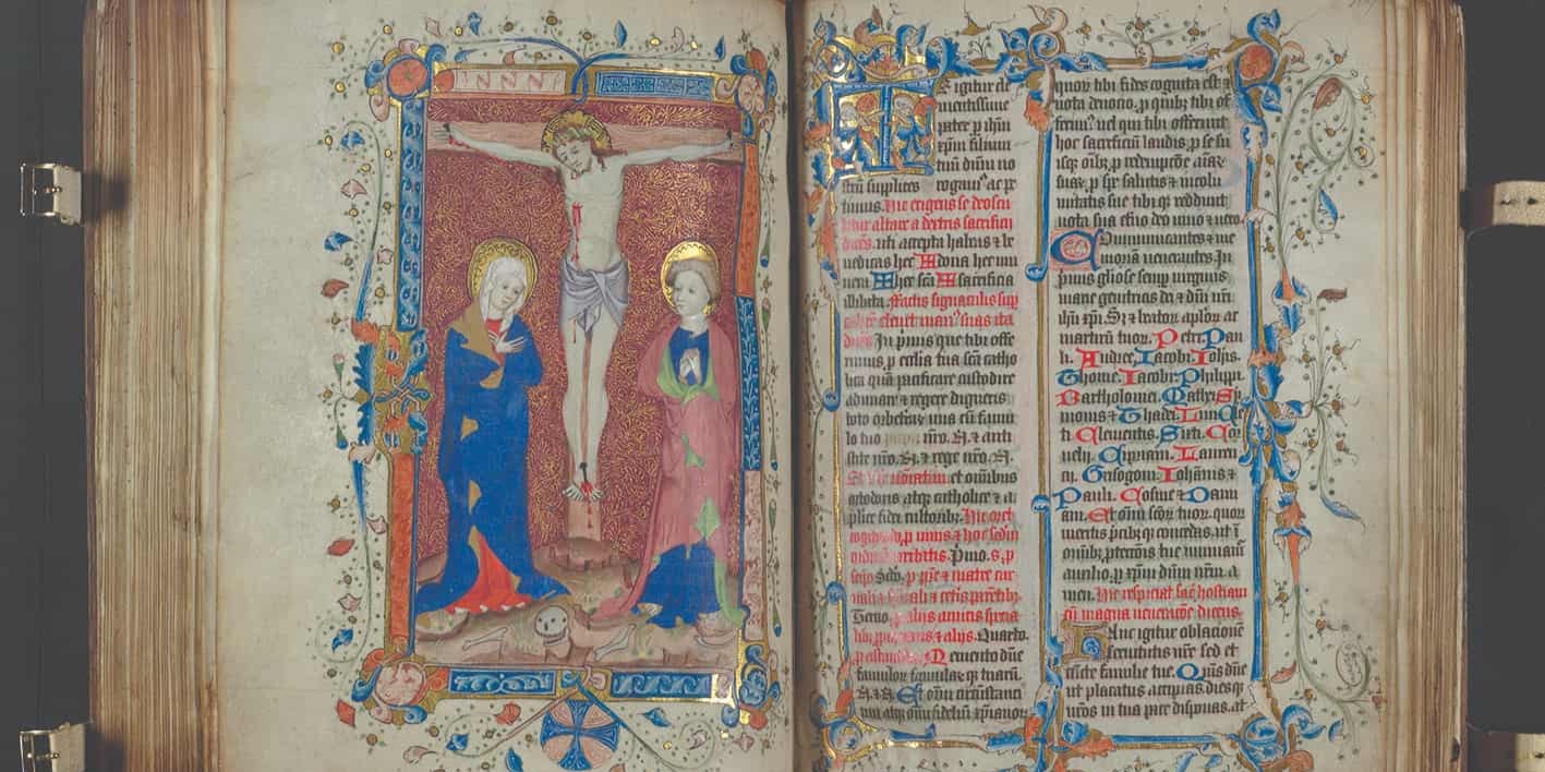 Book with blue and red writing on the right page, drawing of Jesus on the cross and two other people next to him 