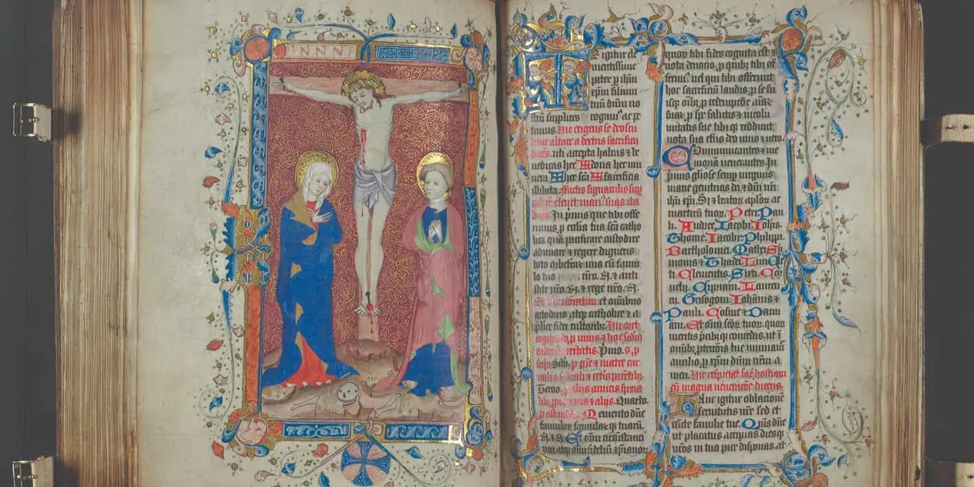 Book with blue and red writing on the right page, drawing of Jesus on the cross and two other people next to him
