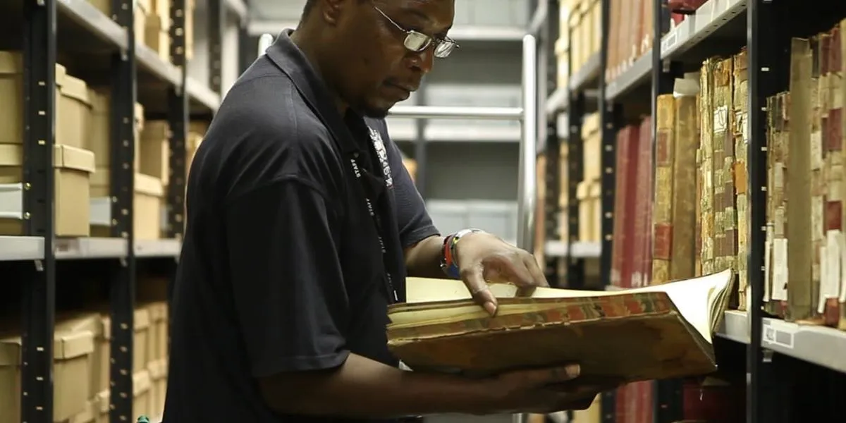 A person reading a book in the archives