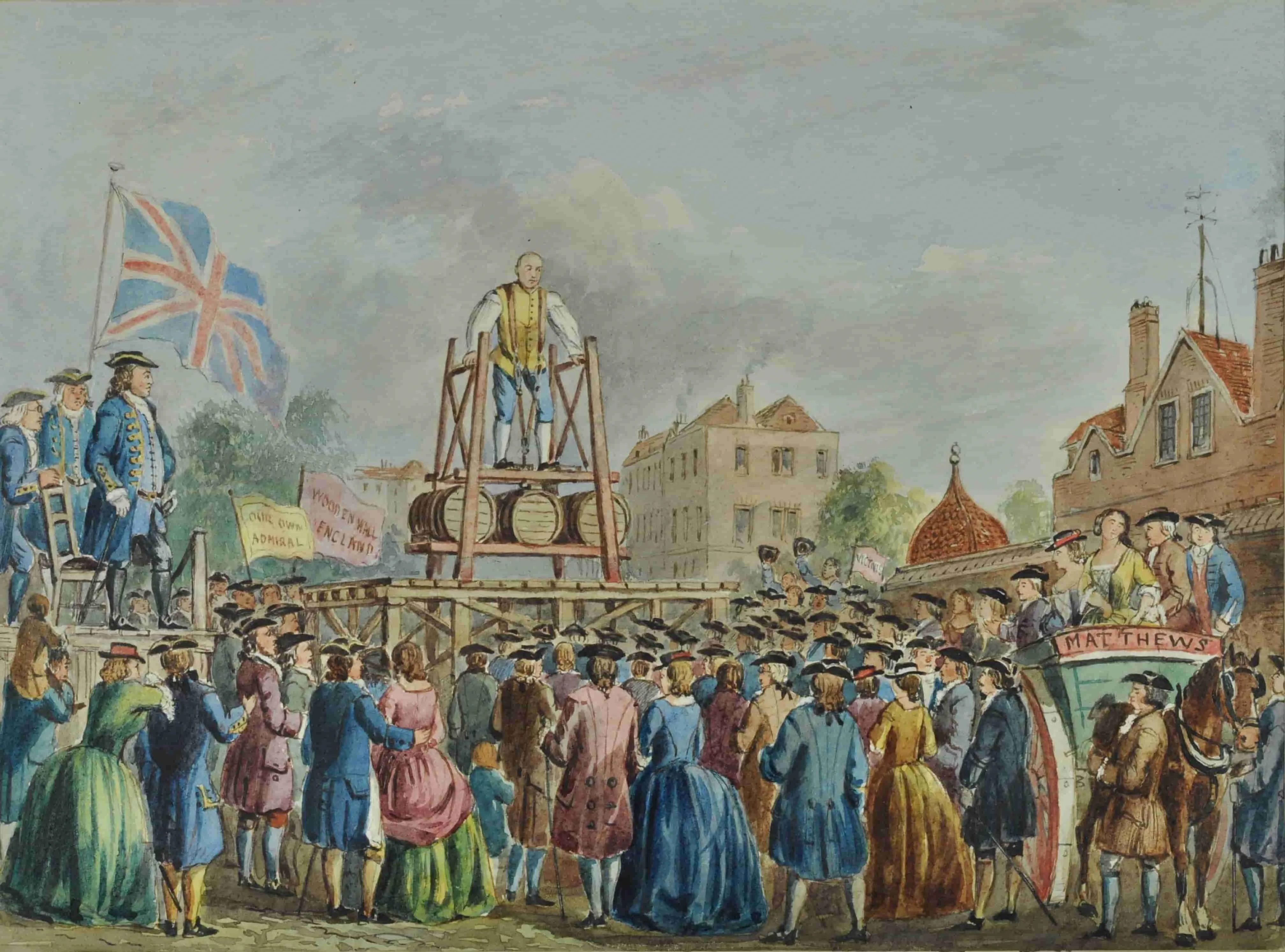 Thomas Topham lifting barrels on a raised structure with a crowd of people watching
