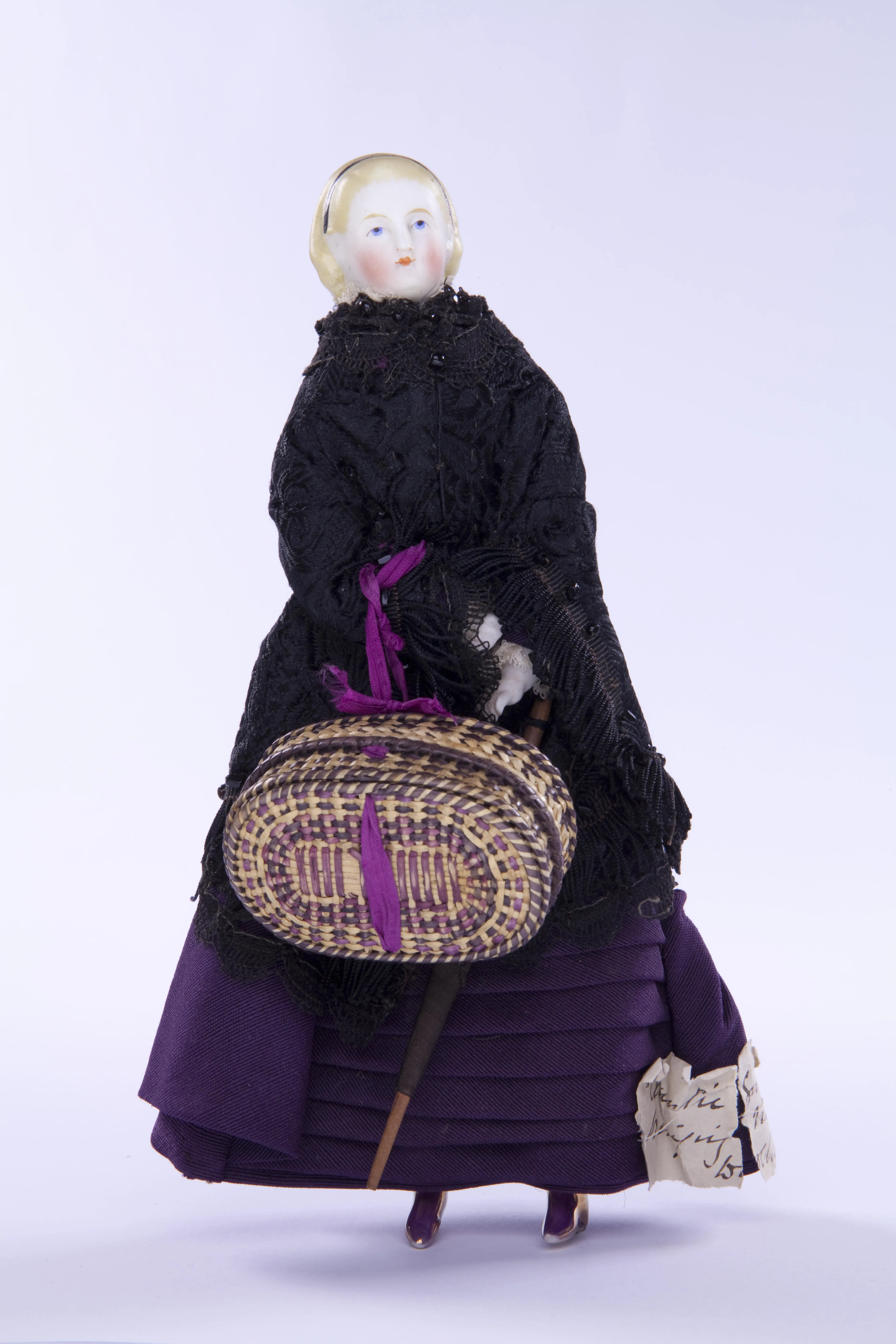 Victorian doll of a woman with a sewing basket