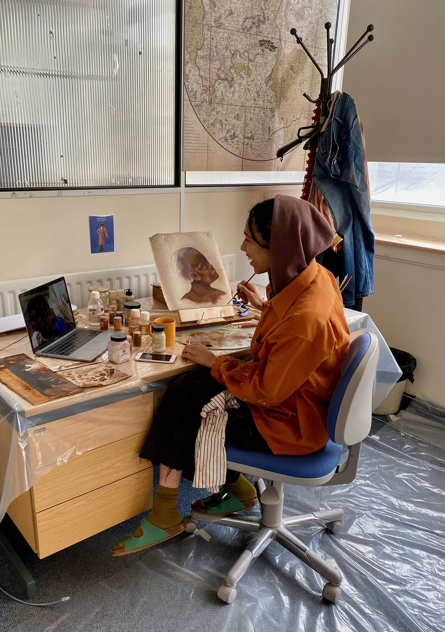Woman sitting on a chair while painting