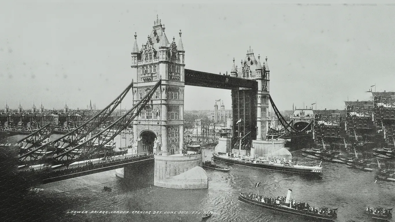 Tower Bridge with lots of people on the bridge and boats on the water
