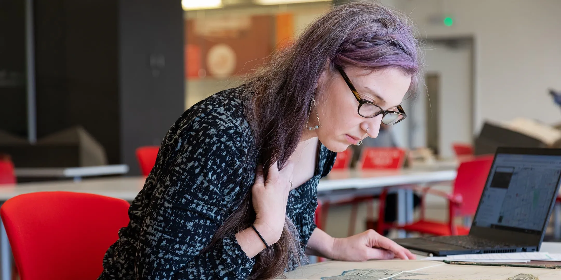 Researcher looking at a map at The London Archives