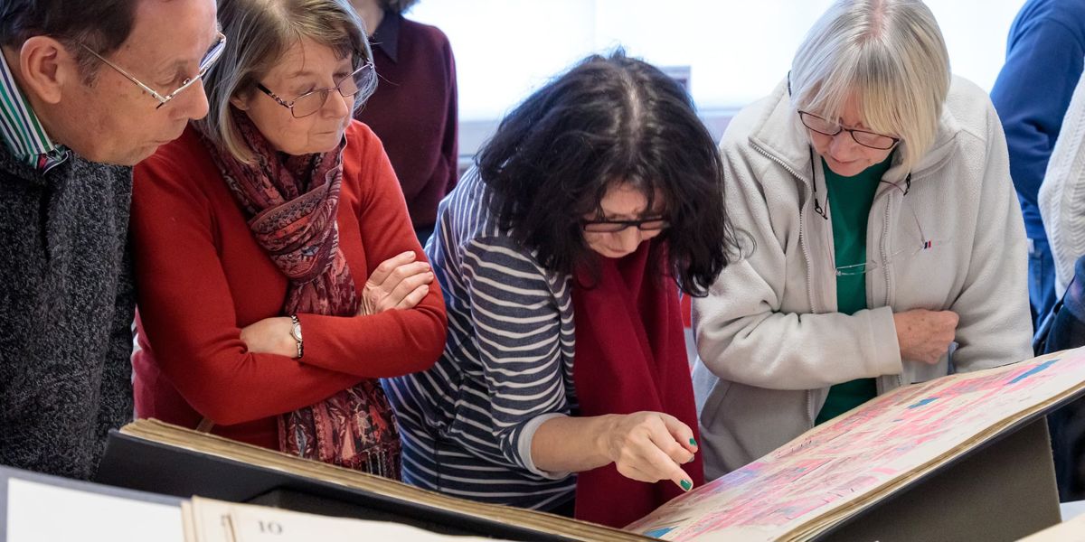 People looking at an archive document