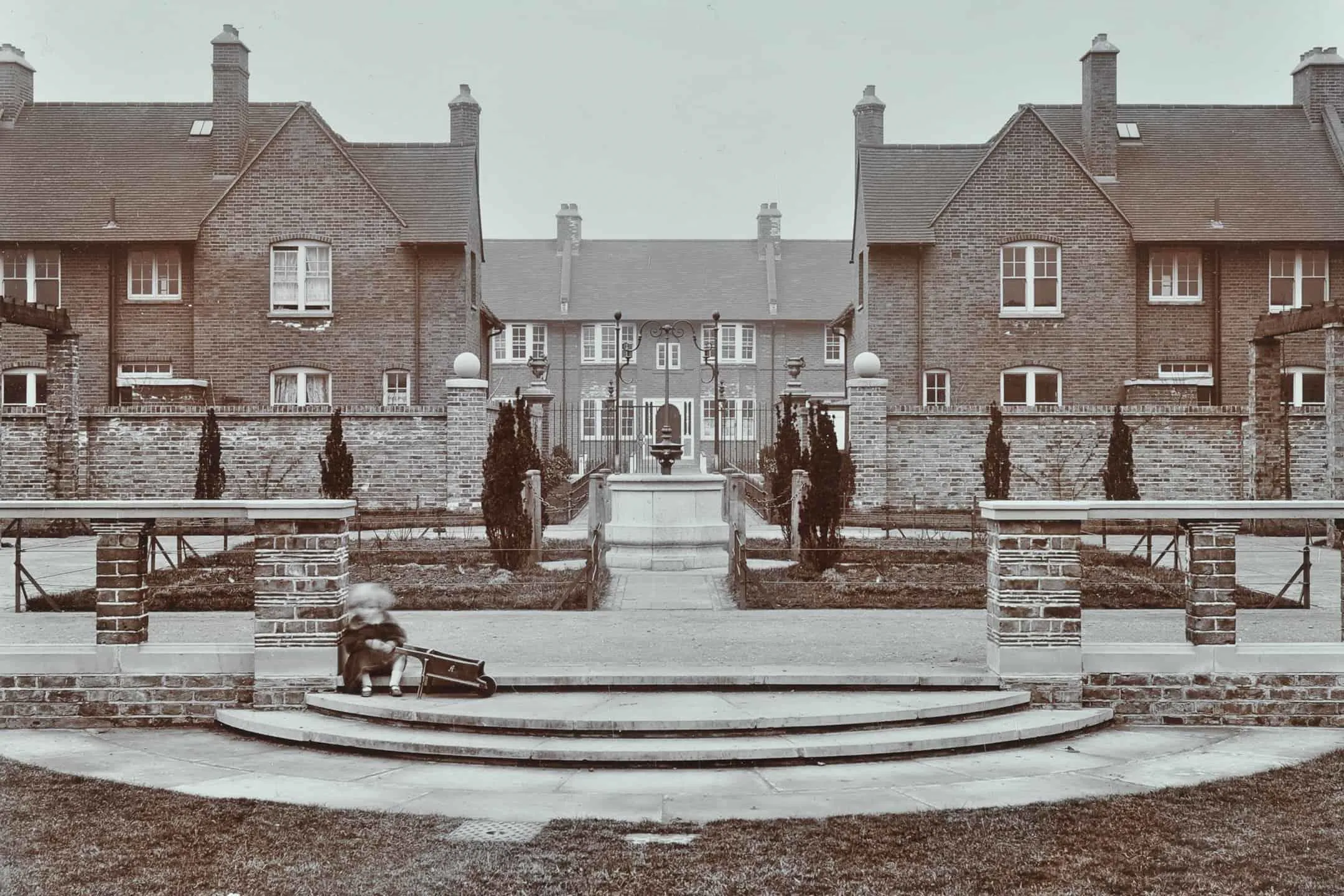 Gardens in estate with a child playing in the foreground