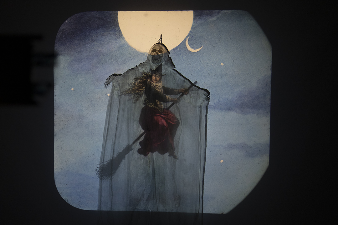 An image of a witch is projected on to a skeleton at the Magic Lantern Show at TLA, 2025.