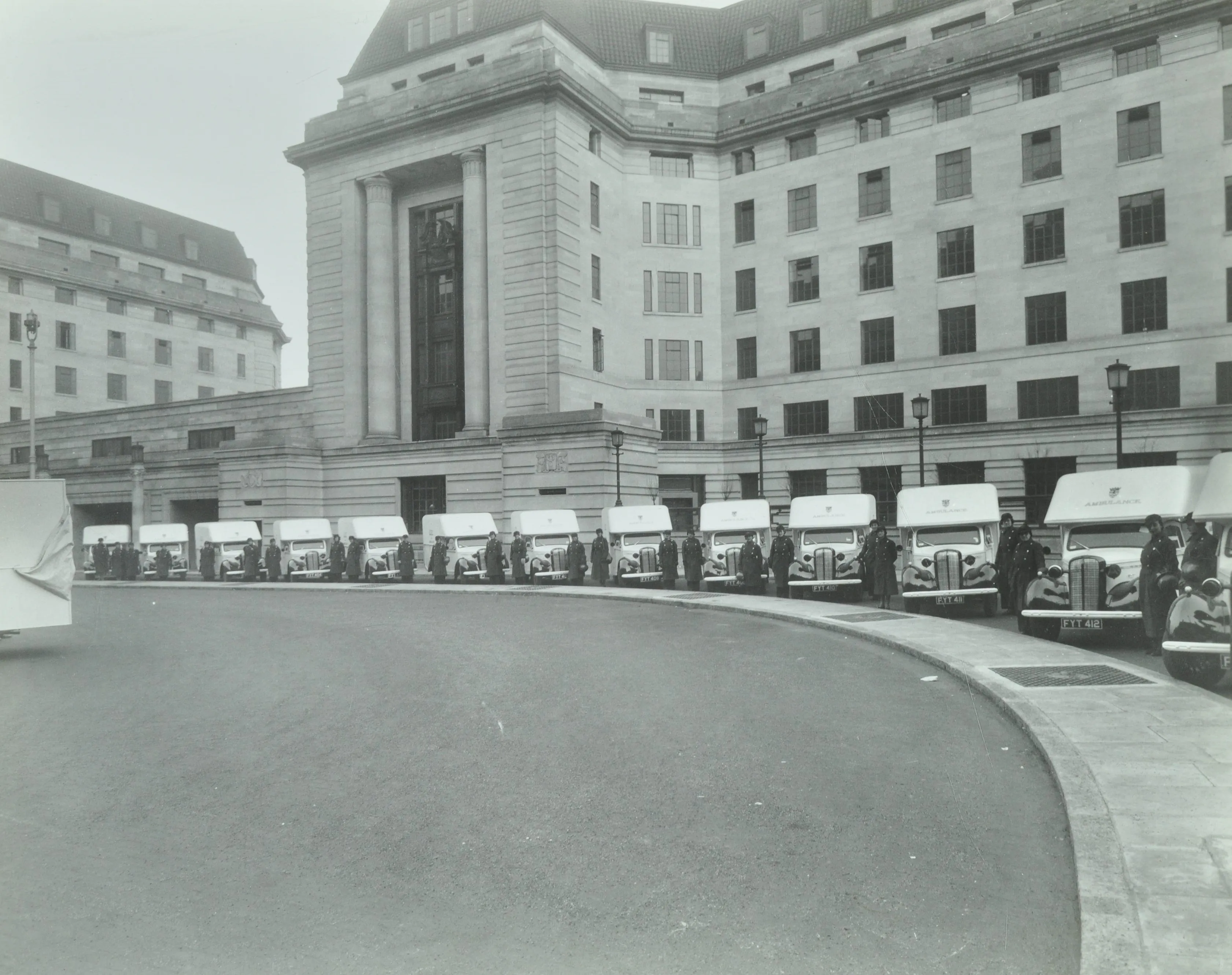 A fleet of ambulances with women drivers outside County Hall
