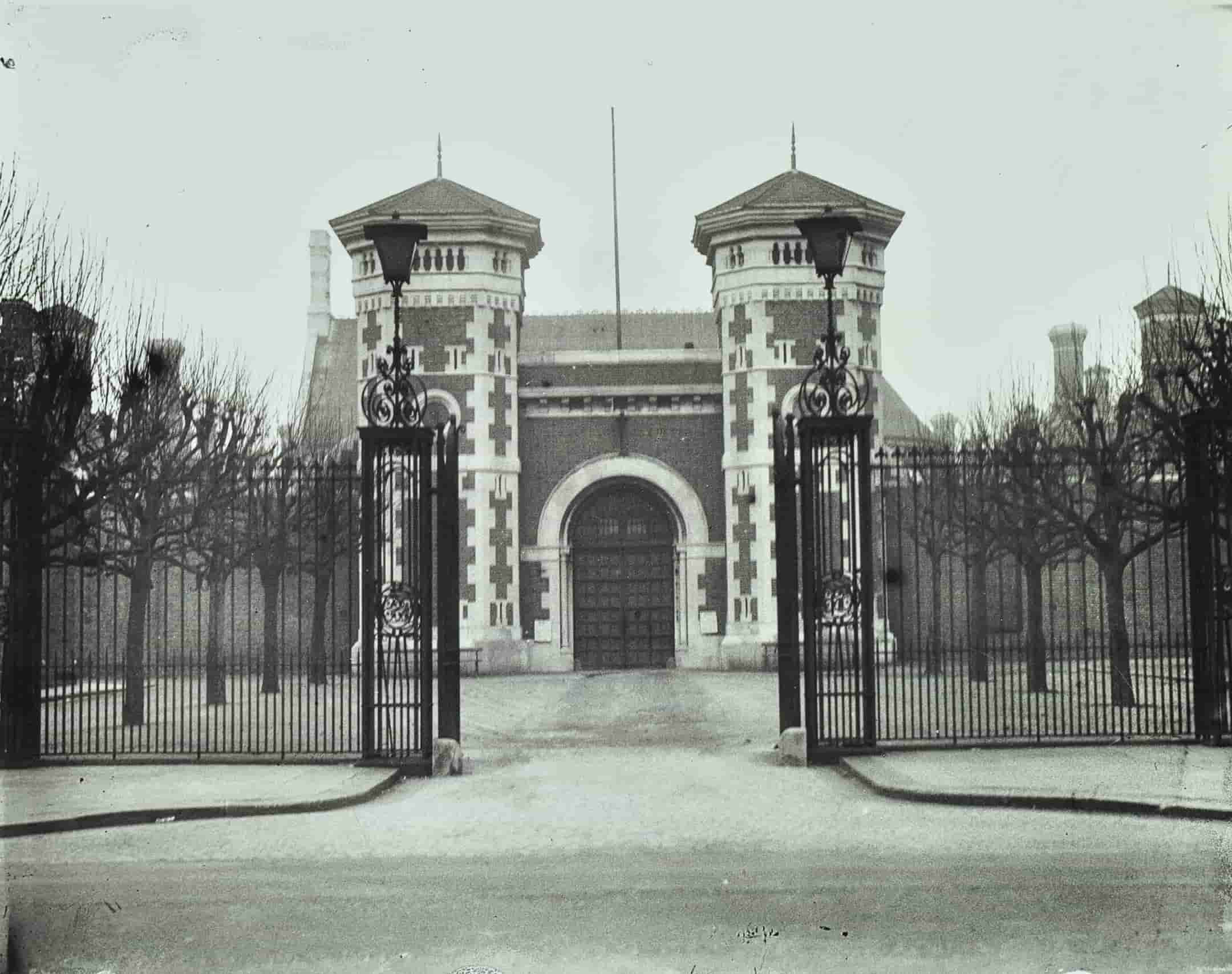 Iron fence and gates in front of towers and large prison doors